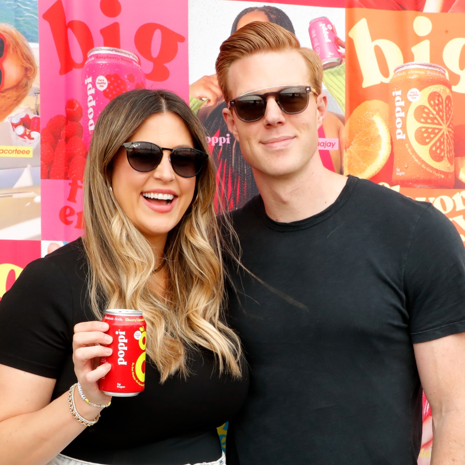 Allison Ellsworth, left, smiles while holding a can of Poppi next to her husband, Stephen