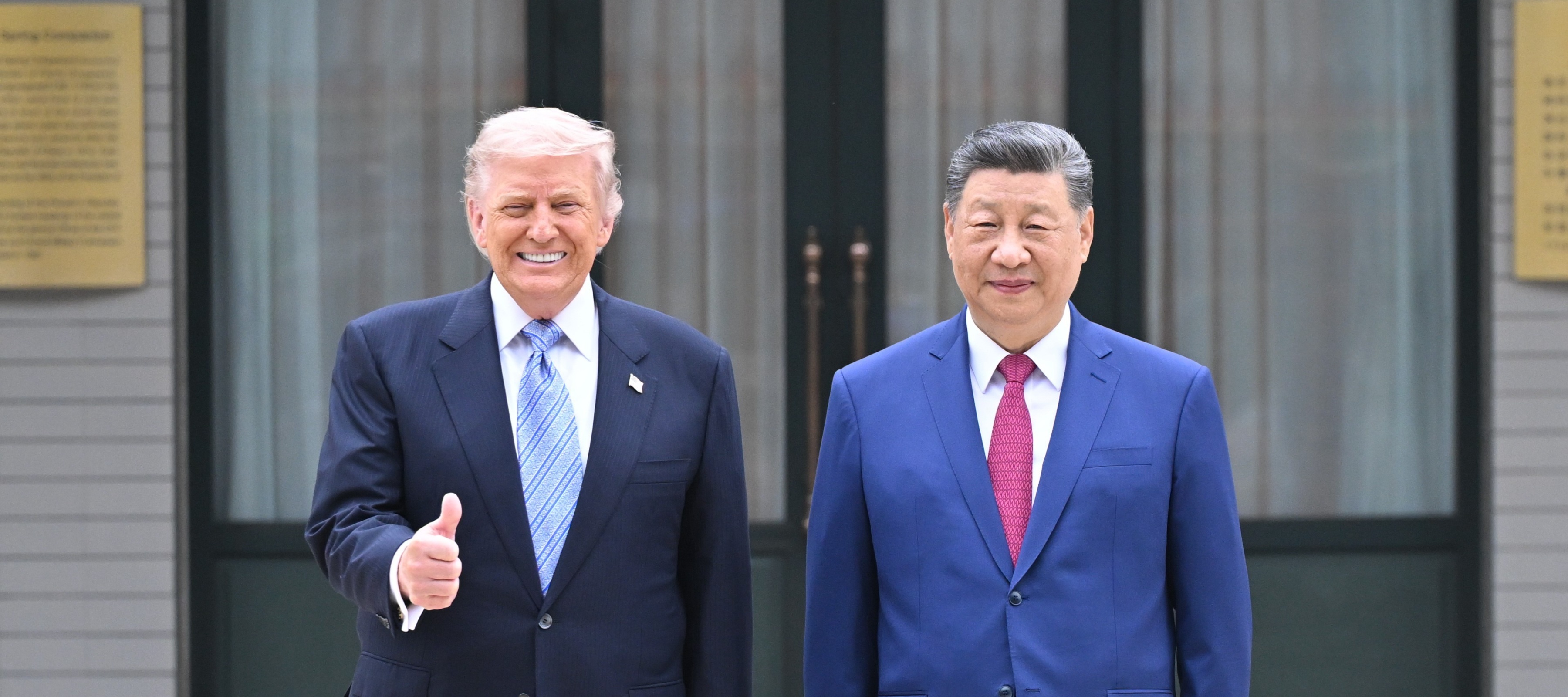 Donald Trump, left, gives a thumbs up as he stands next to Xi Jinping