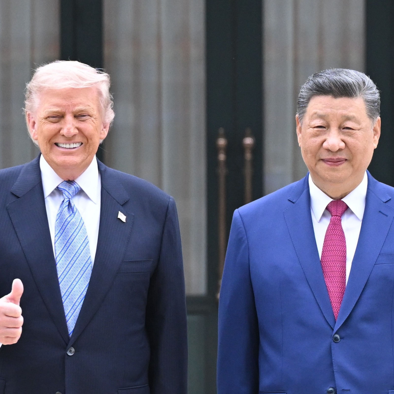 Donald Trump, left, gives a thumbs up as he stands next to Xi Jinping