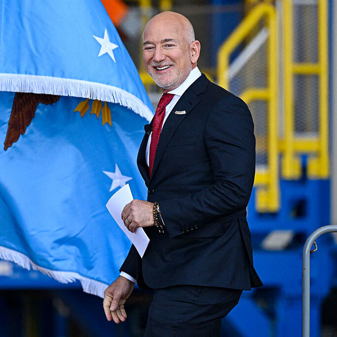 Blue Origin CEO Jeff Bezos arrives onstage ahead of US Defense Secretary Pete Hegseth at Blue Origin in Cape Canaveral, Florida, on February 2, 2026.