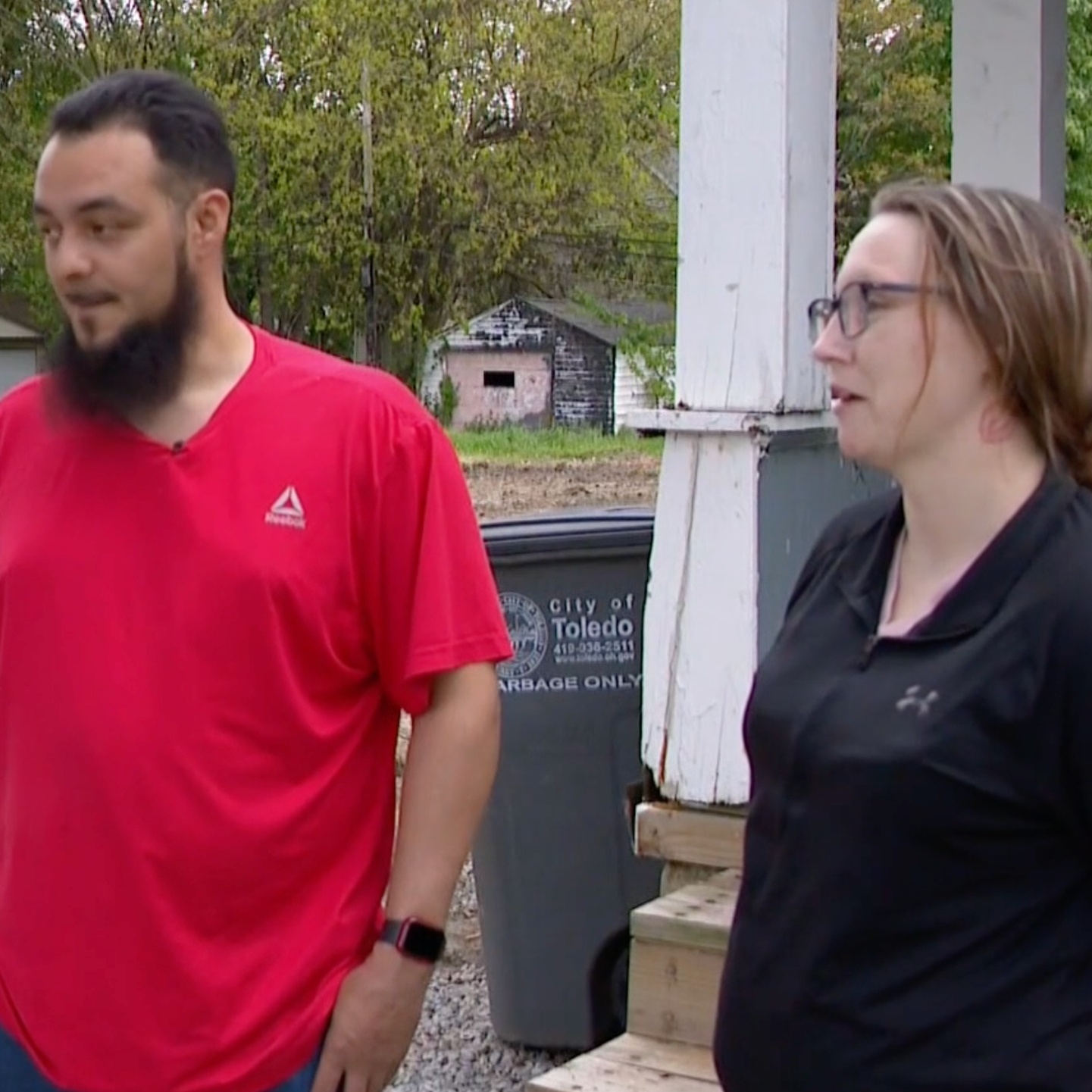 Raphael Rodriguez and Alexandria Martin stand by their home which was damaged by the demolition of a vacant home next door.