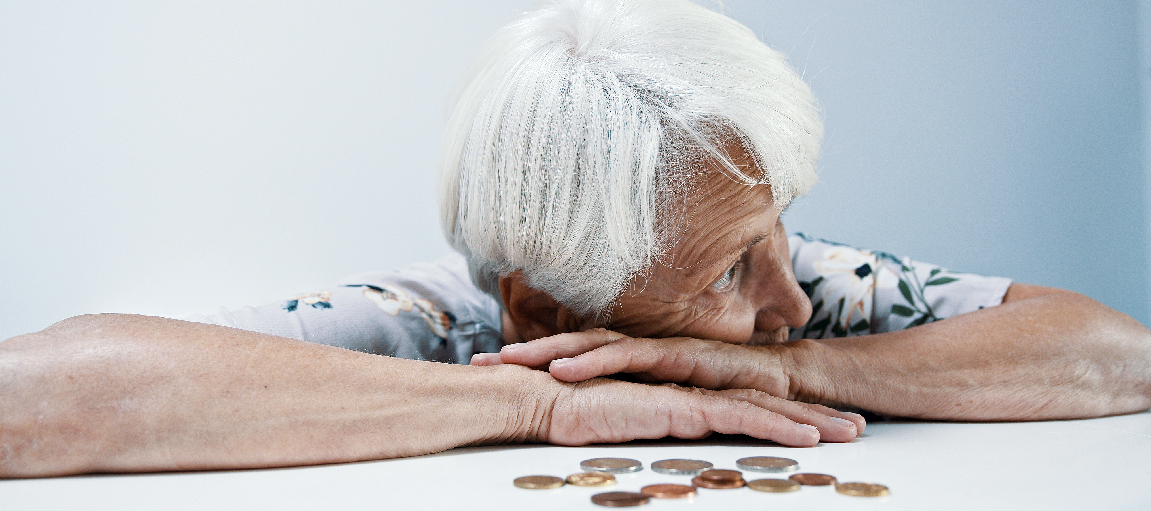 An older woman looks pensive with her change.