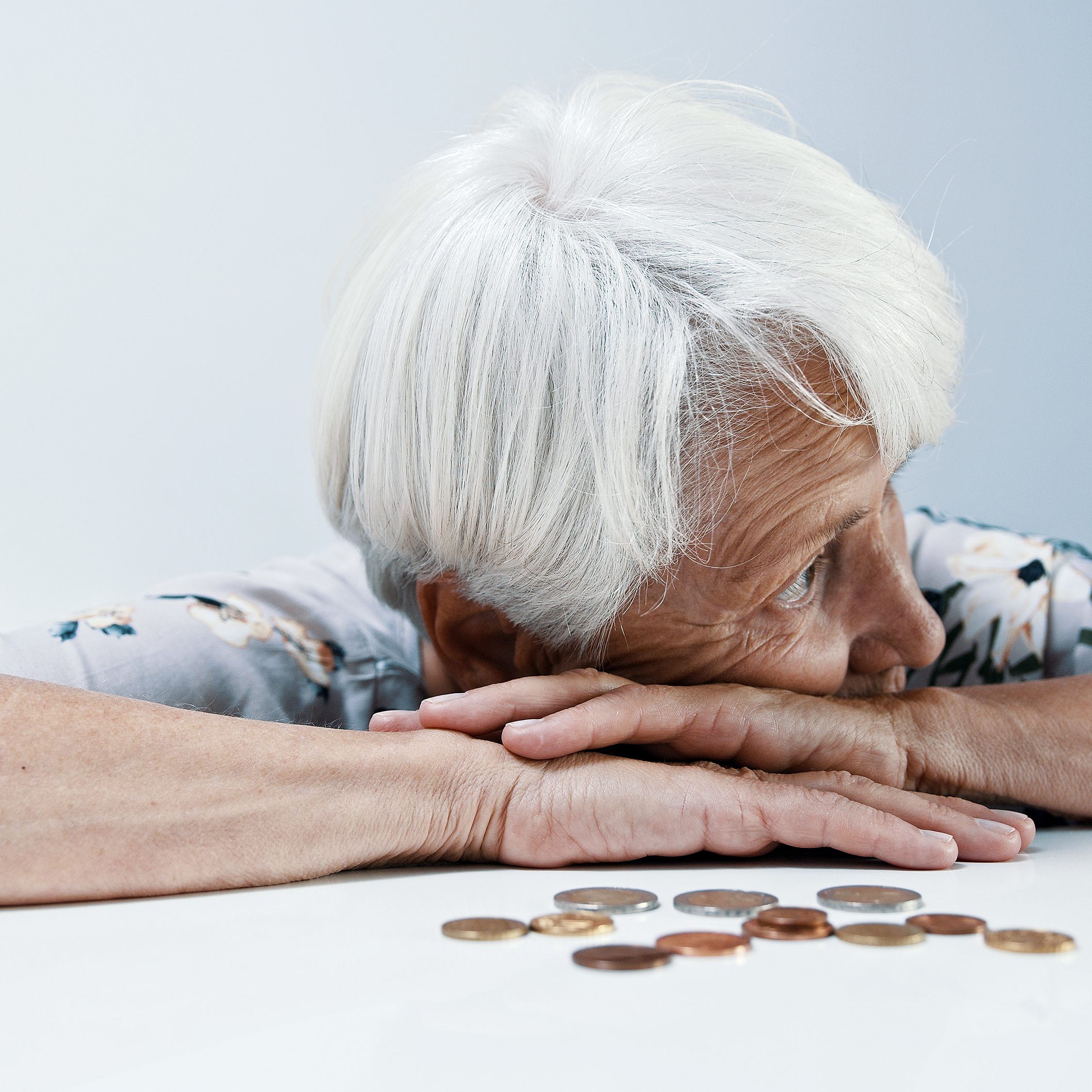 An older woman looks pensive with her change.