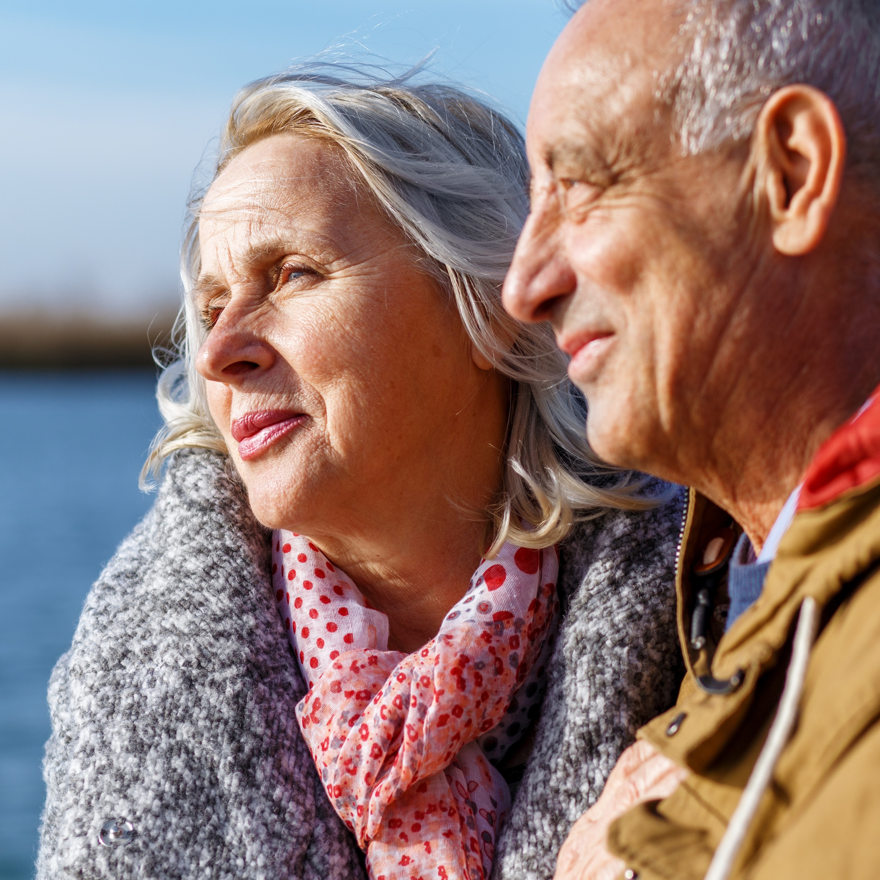 Older couple smiling by lake