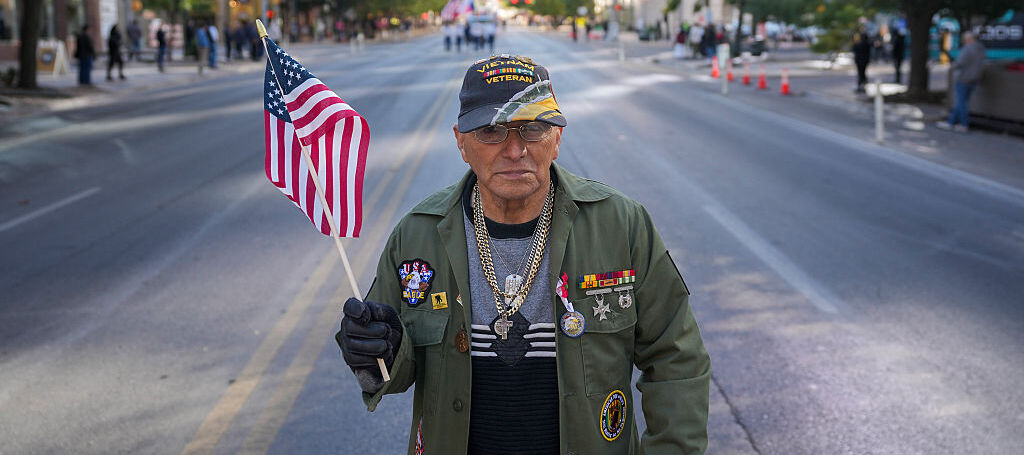 A photo of a veteran waving an American flag