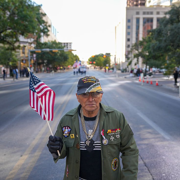 A photo of a veteran waving an American flag