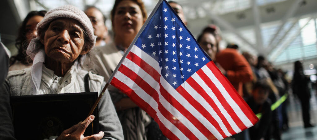 Ana Julia Ayala (L), an immigrant from El Salvador, waits for her son to depart a naturalization ceremony