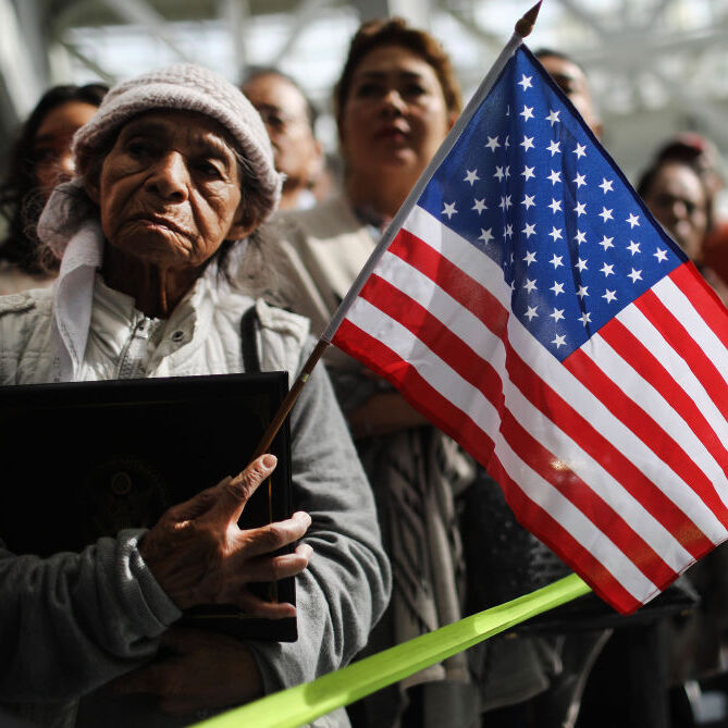Ana Julia Ayala (L), an immigrant from El Salvador, waits for her son to depart a naturalization ceremony