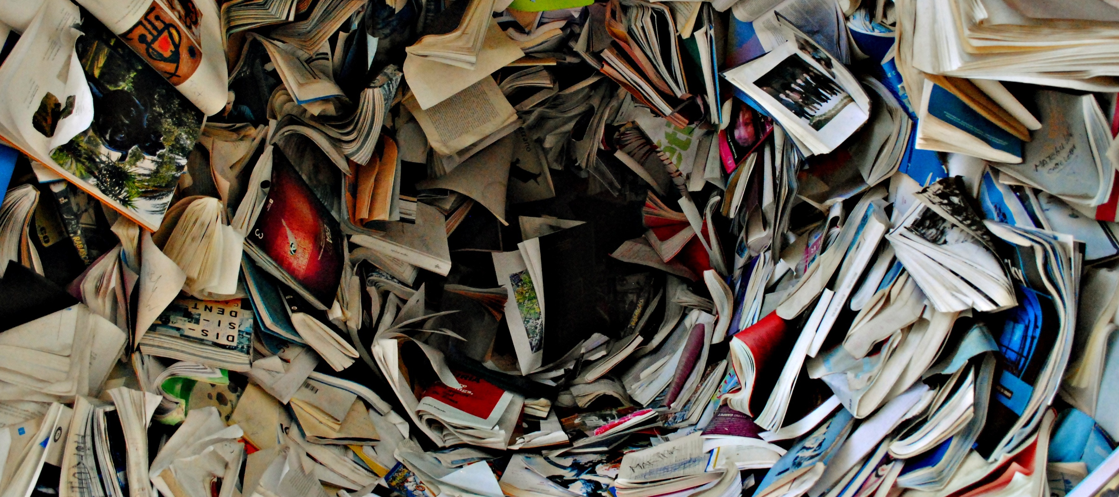 Books and letters getting sucked into a black void