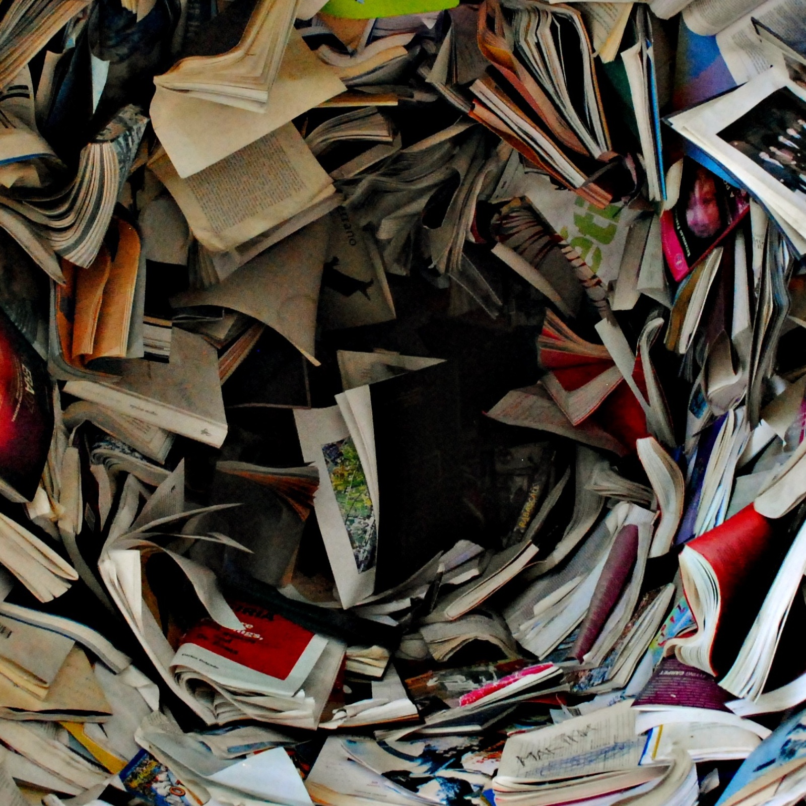Books and letters getting sucked into a black void