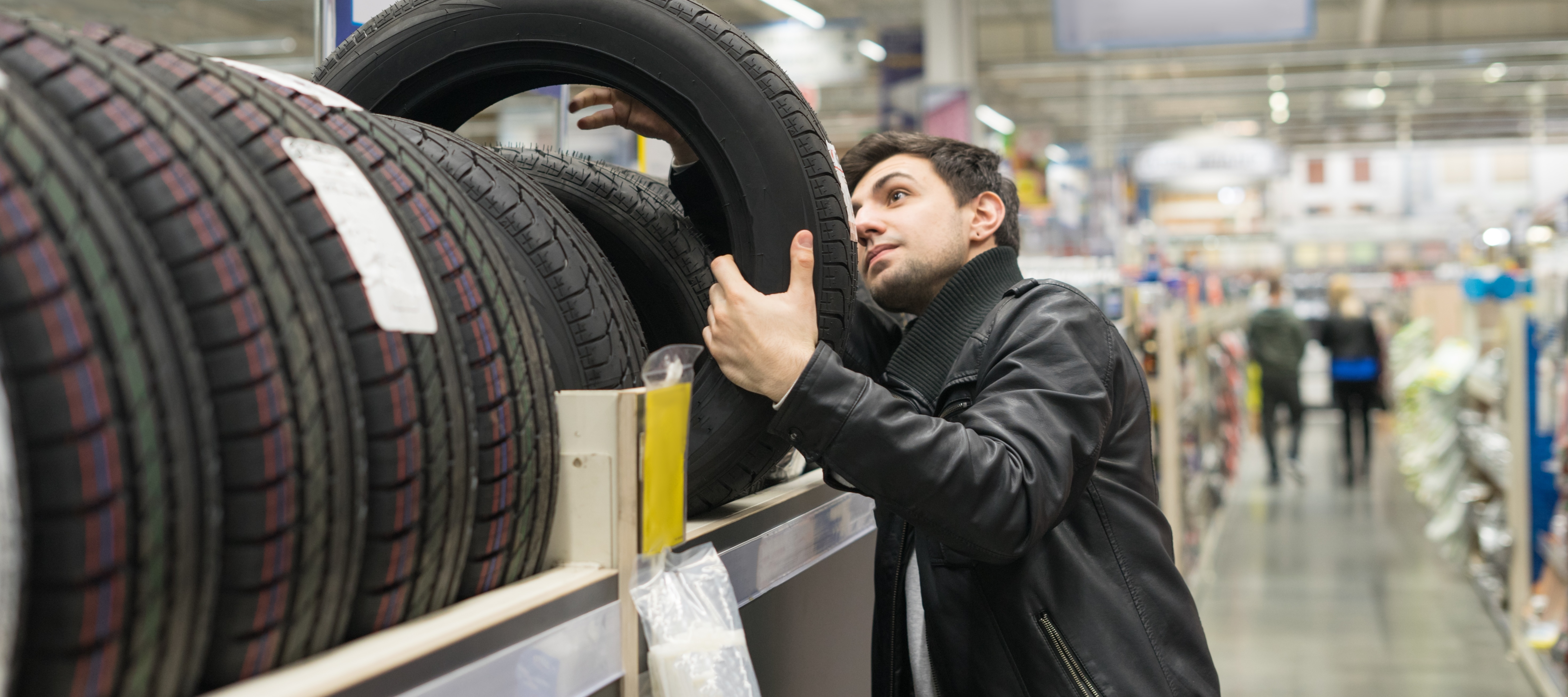 Man shopping for tires at auto parts store