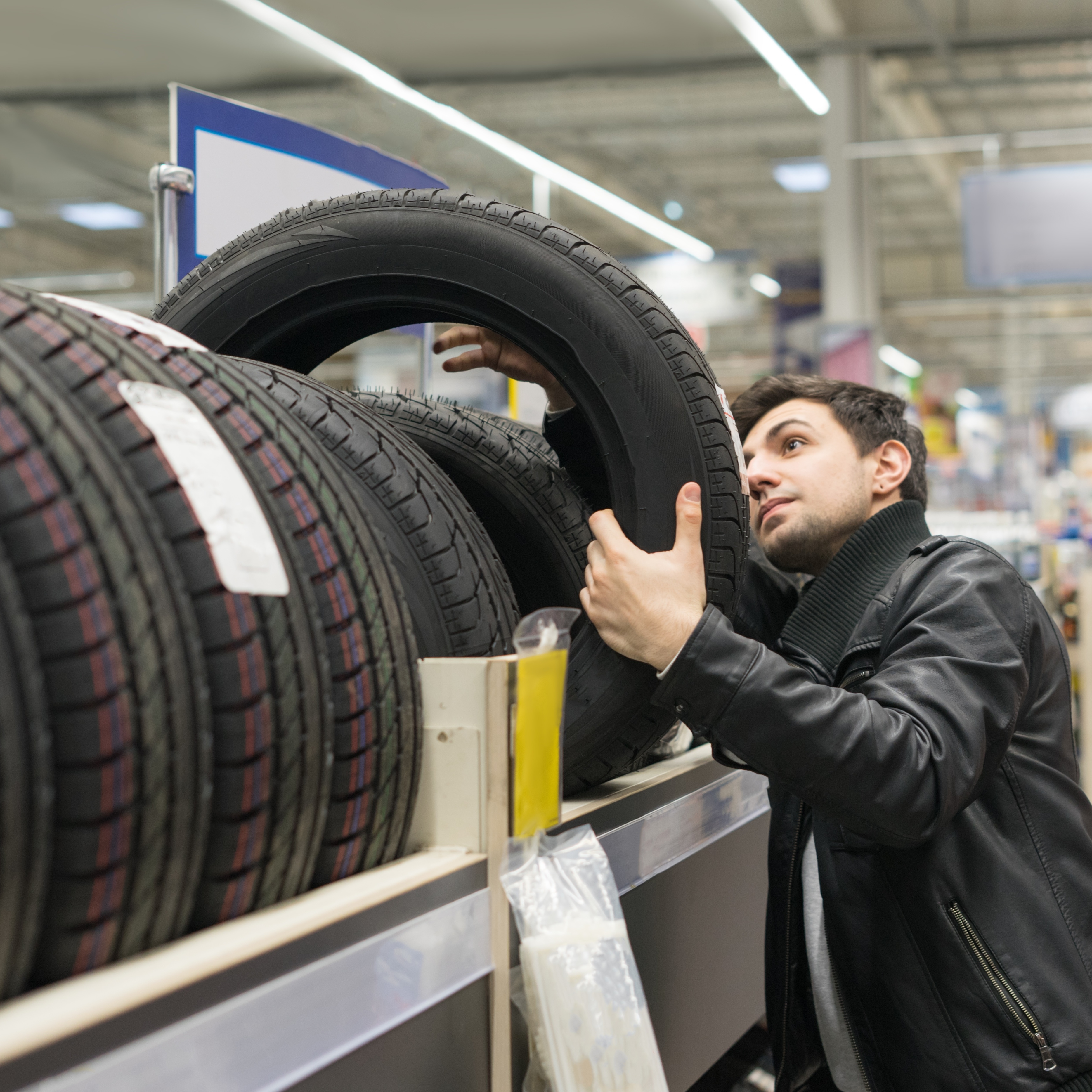 Man shopping for tires at auto parts store