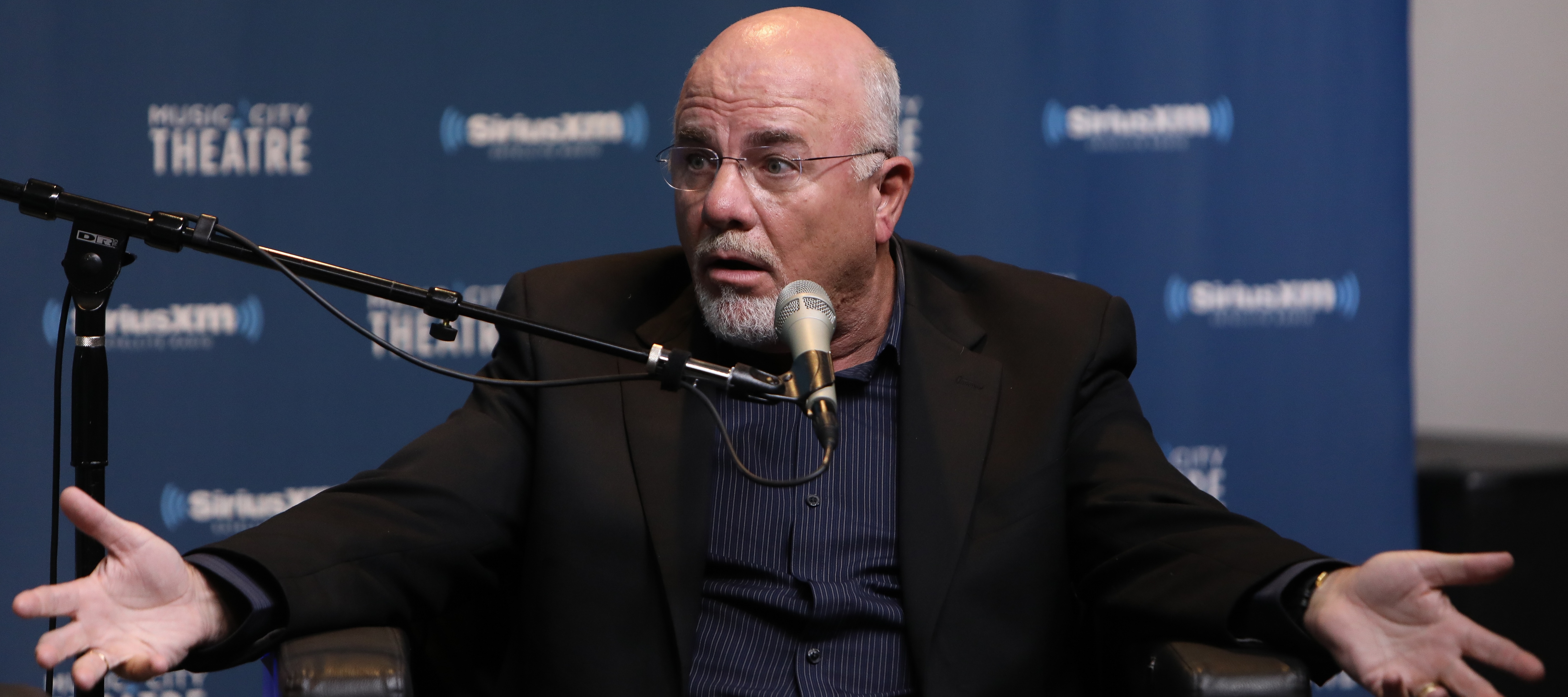Dave Ramsey spreads his arms in disbelief.