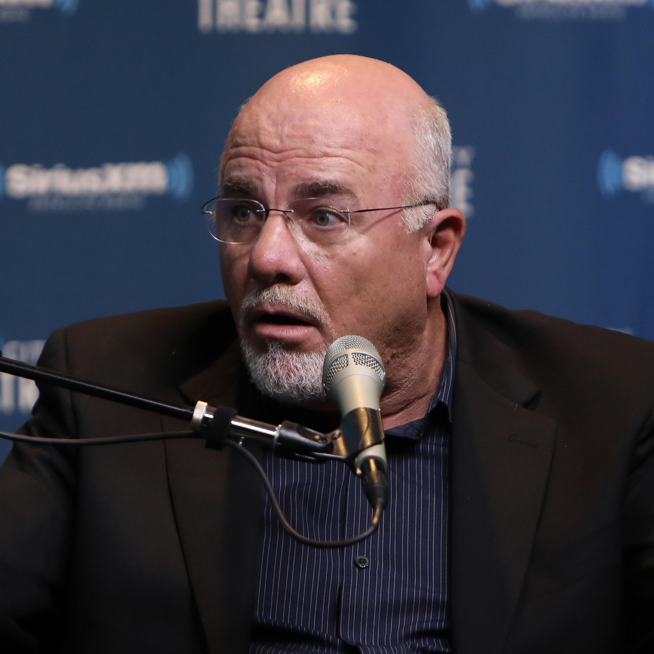 Dave Ramsey spreads his arms in disbelief.