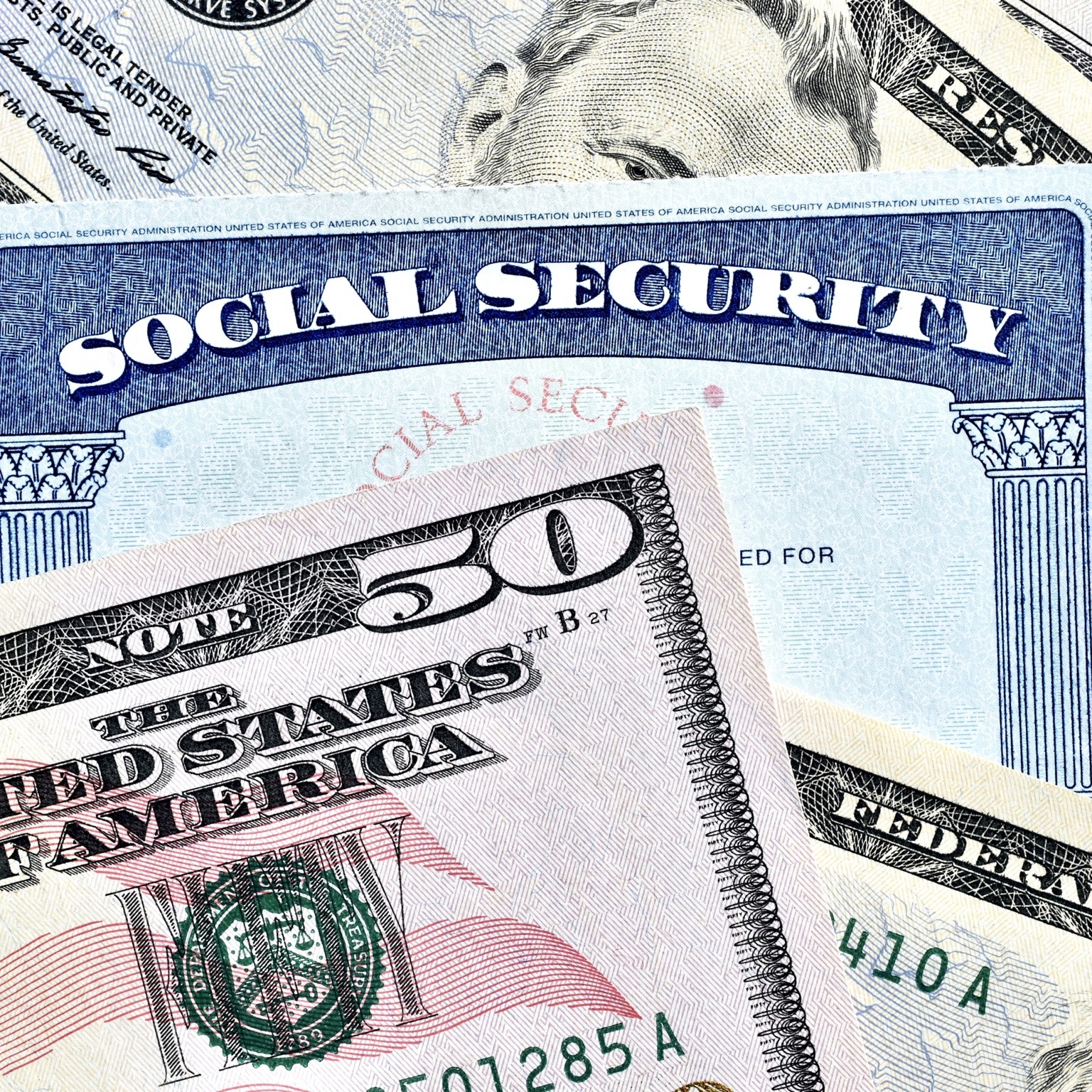 An overhead, detailed shot shows a Social Security card displayed with a partially obscured fifty dollar bill.