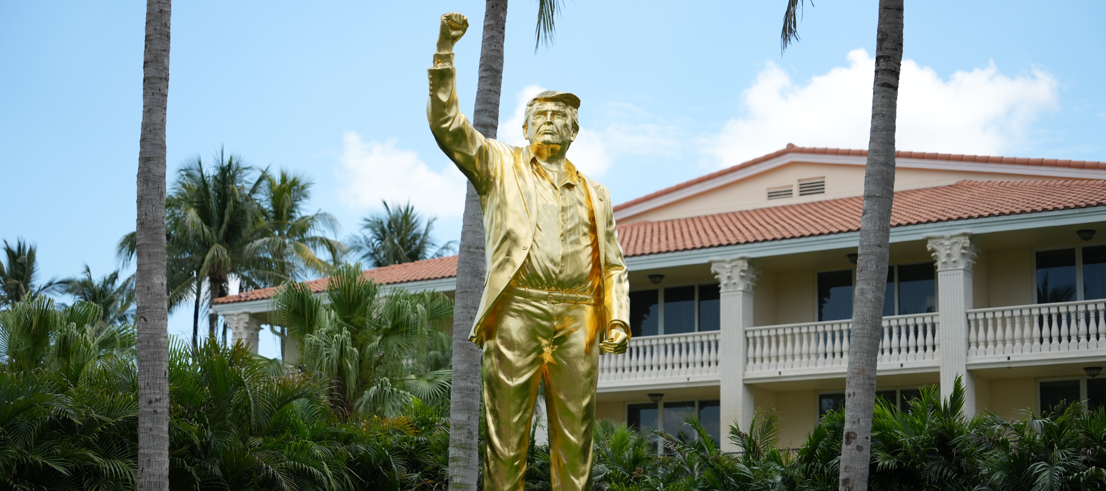 A gold statue of Donald Trump with him raising his fist in the air