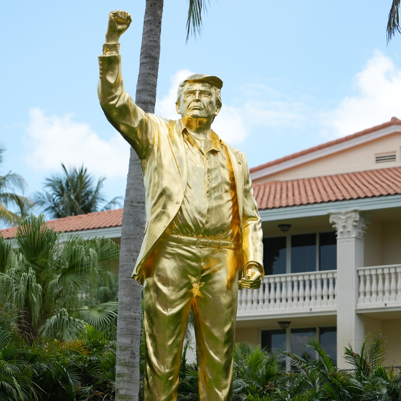 A gold statue of Donald Trump with him raising his fist in the air