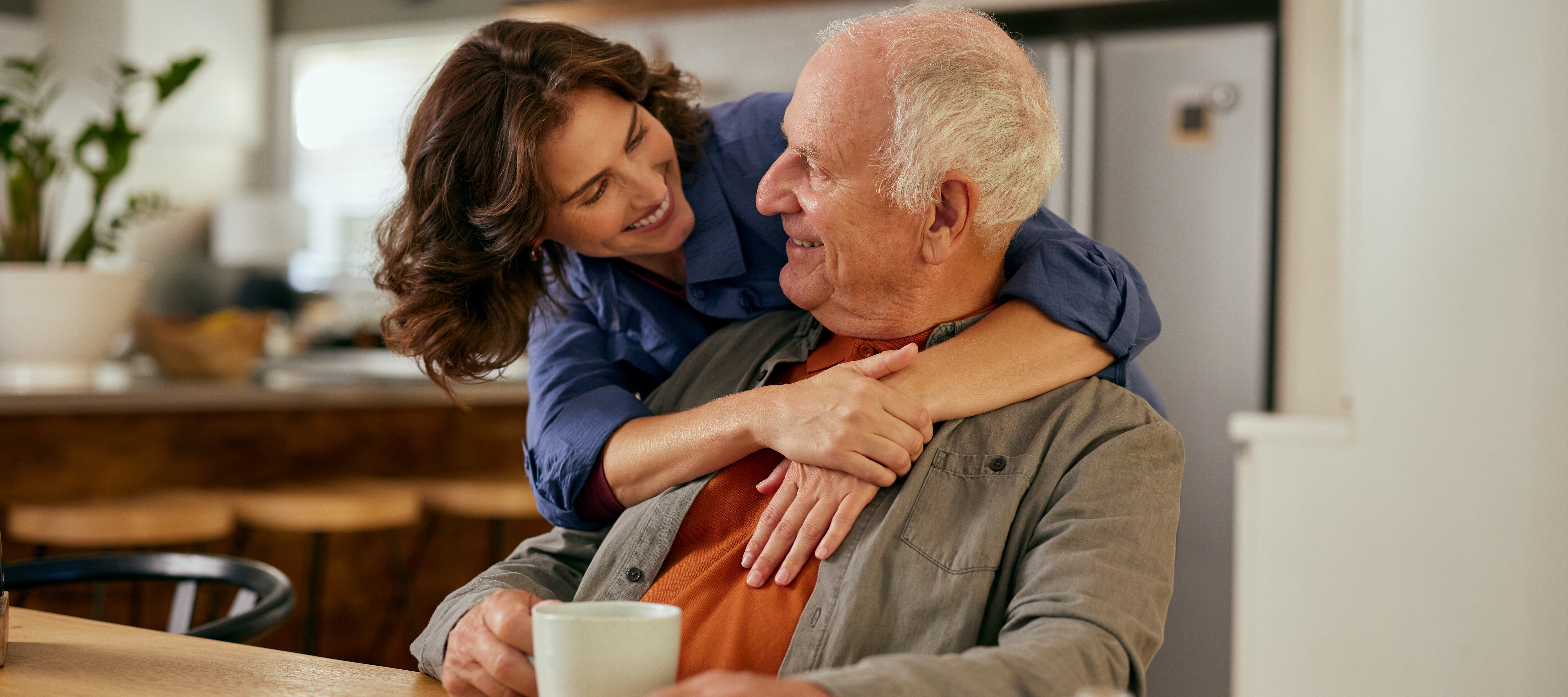 A father shares a moment with his adult daughter.