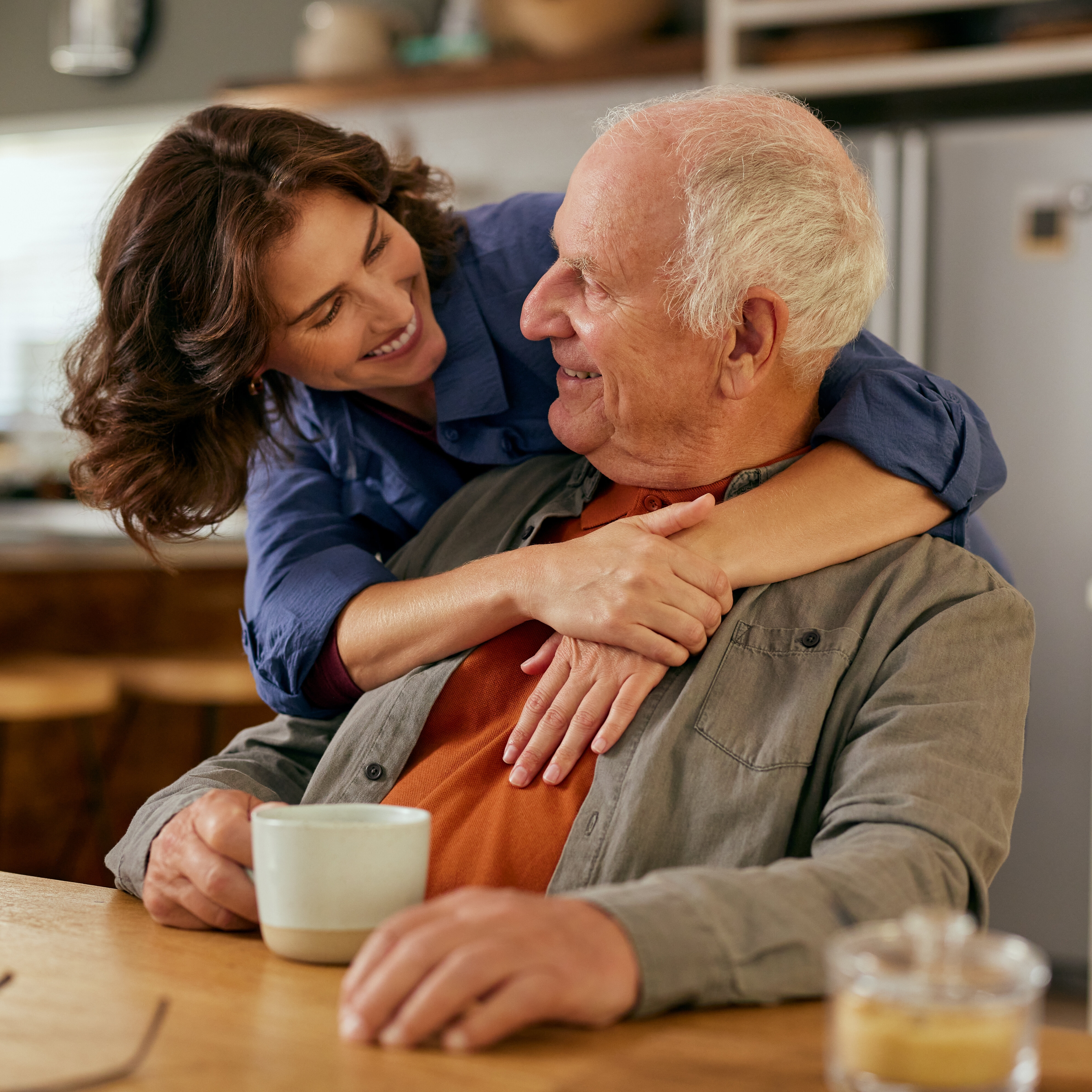 A father shares a moment with his adult daughter.