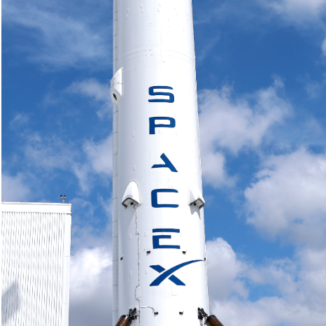 Ed Elson on the podcast Prof G Markets juxtaposed against a SpaceX rocket.