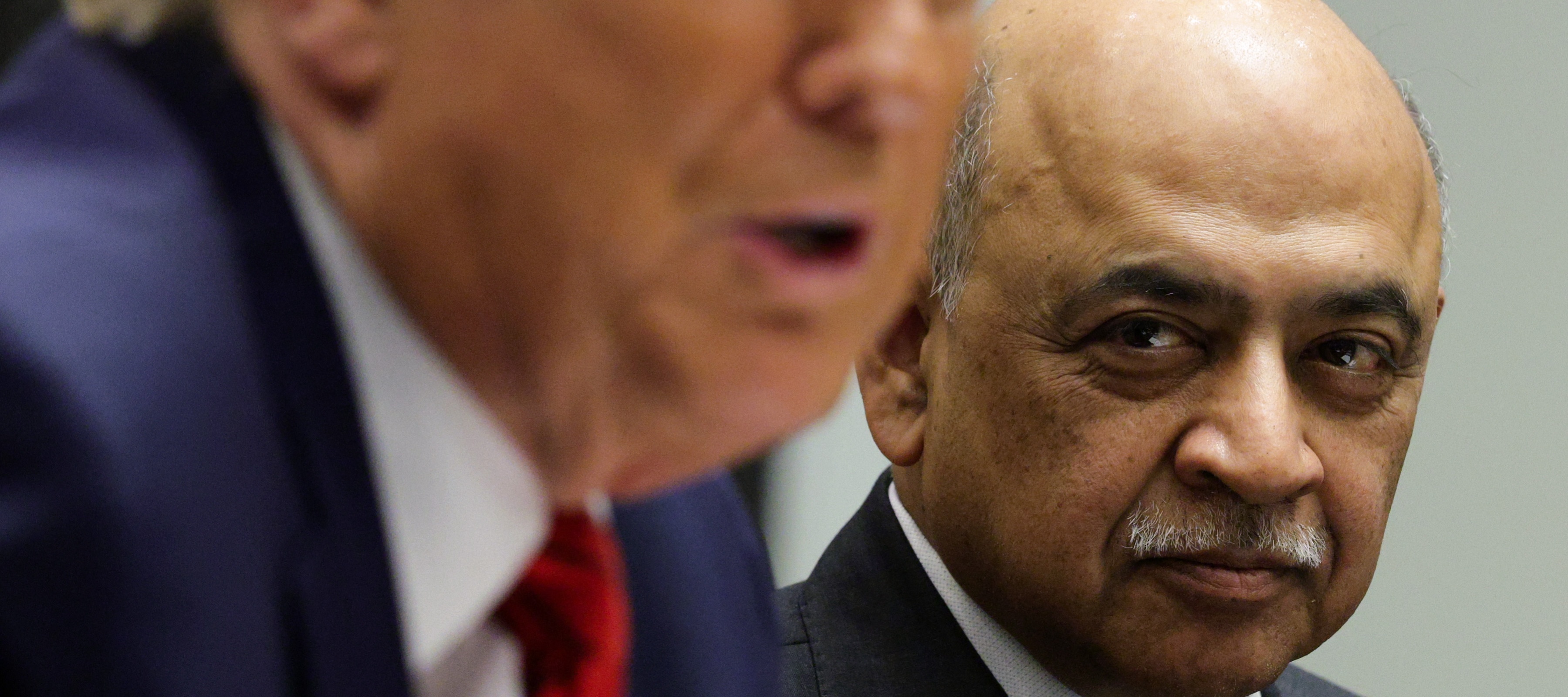 IBM CEO Arvind Krishna looks on as Donald Trump speaks