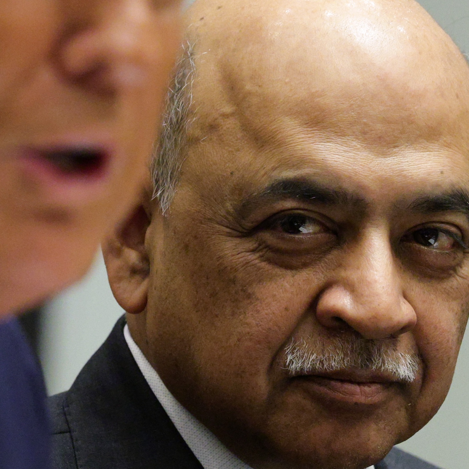 IBM CEO Arvind Krishna looks on as Donald Trump speaks