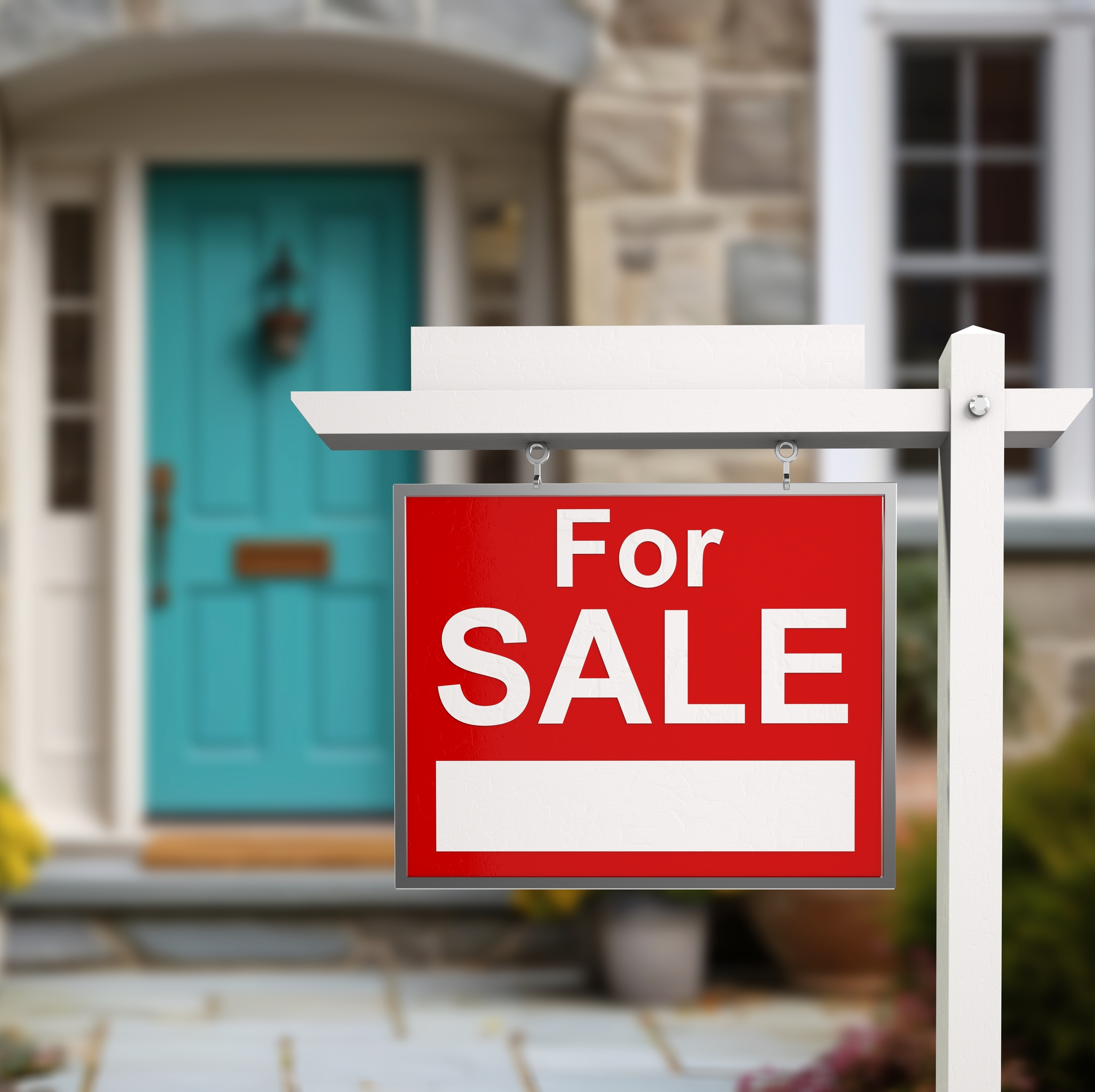 For sale sign posted by real estate agency on street