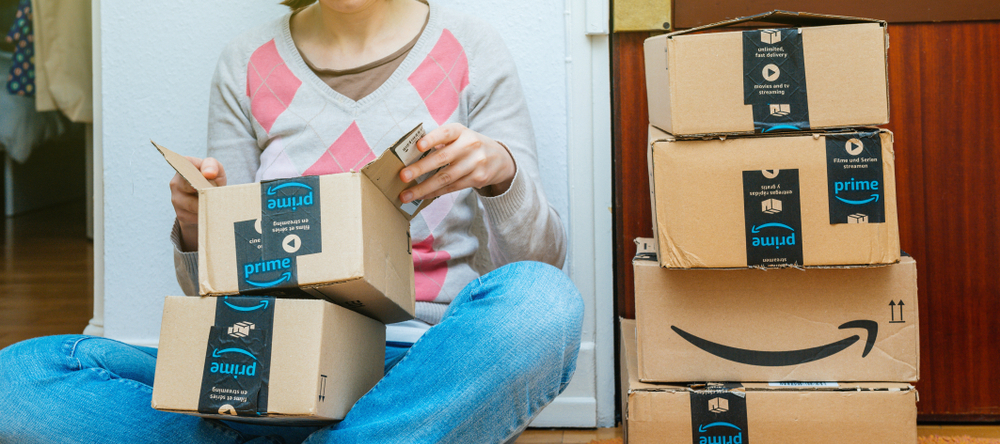 A photo of a woman opening Amazon packages