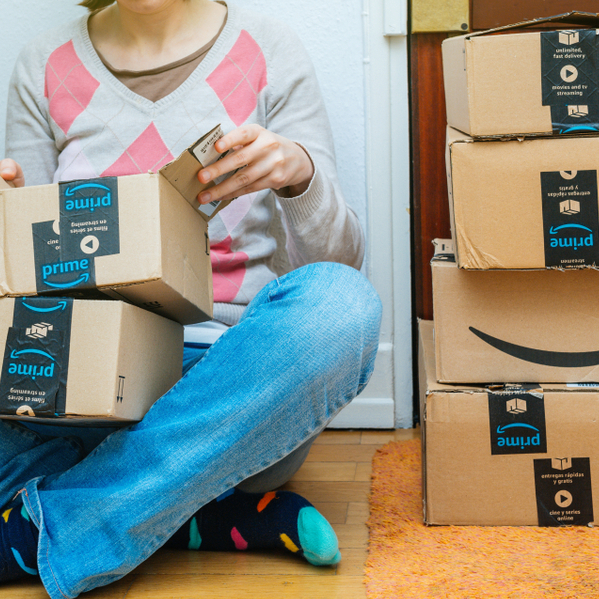 A photo of a woman opening Amazon packages