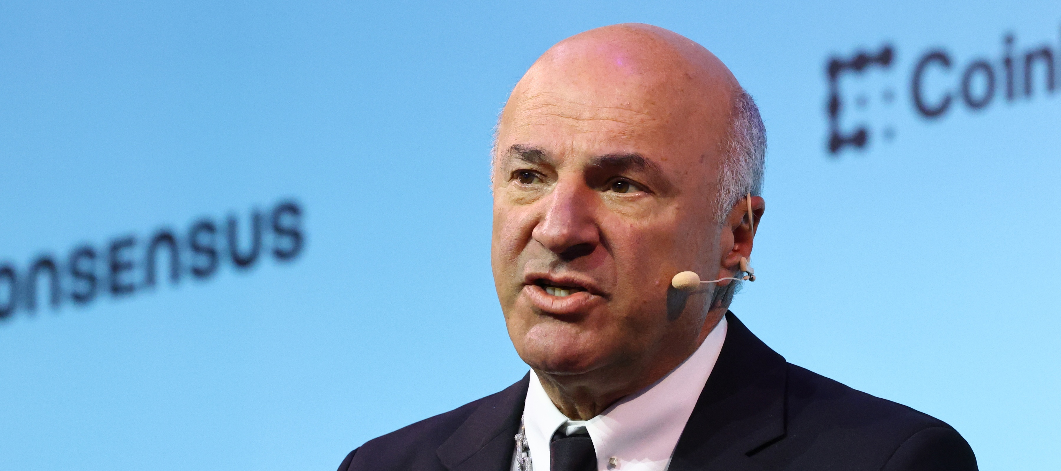 A close-up photo of Kevin O'Leary, speaking on stage at an event