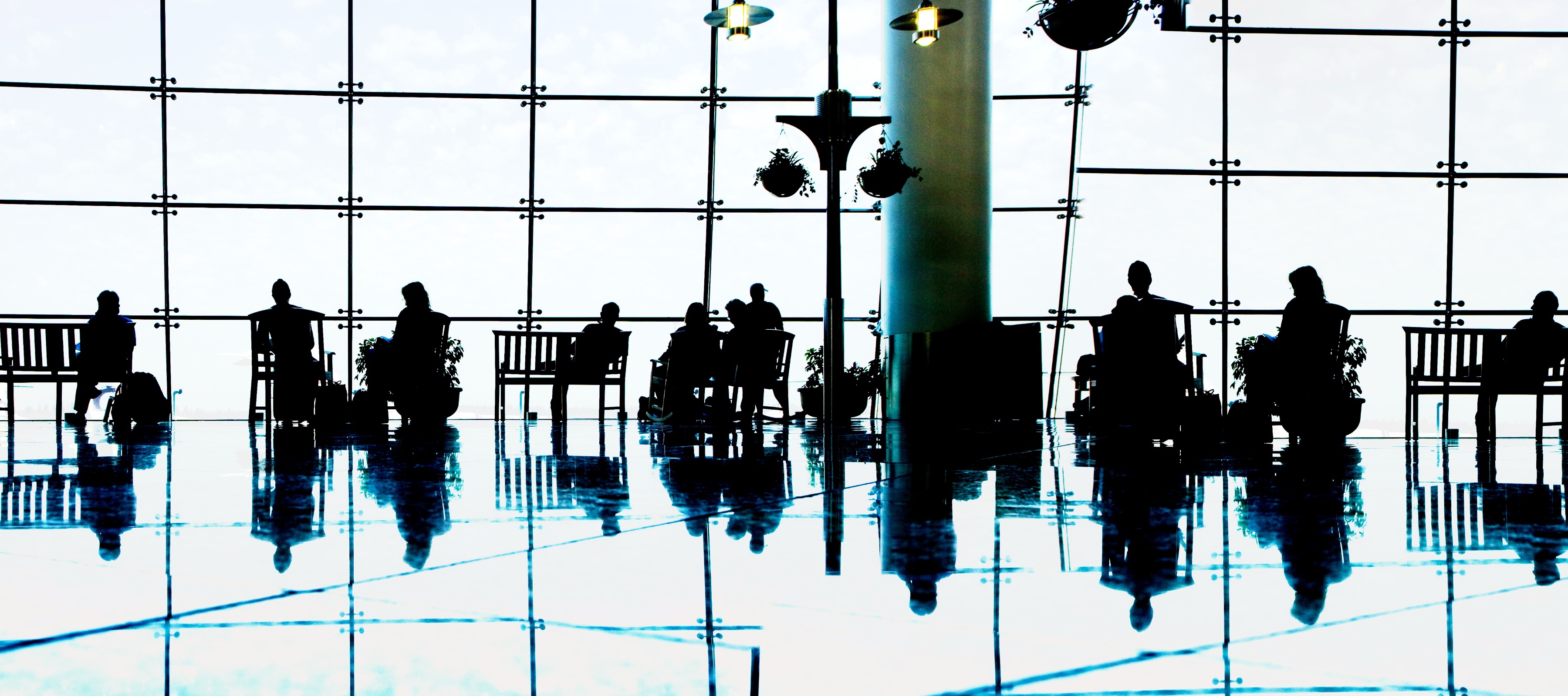 A high-contrast photo of people waiting in a premium airport lounge