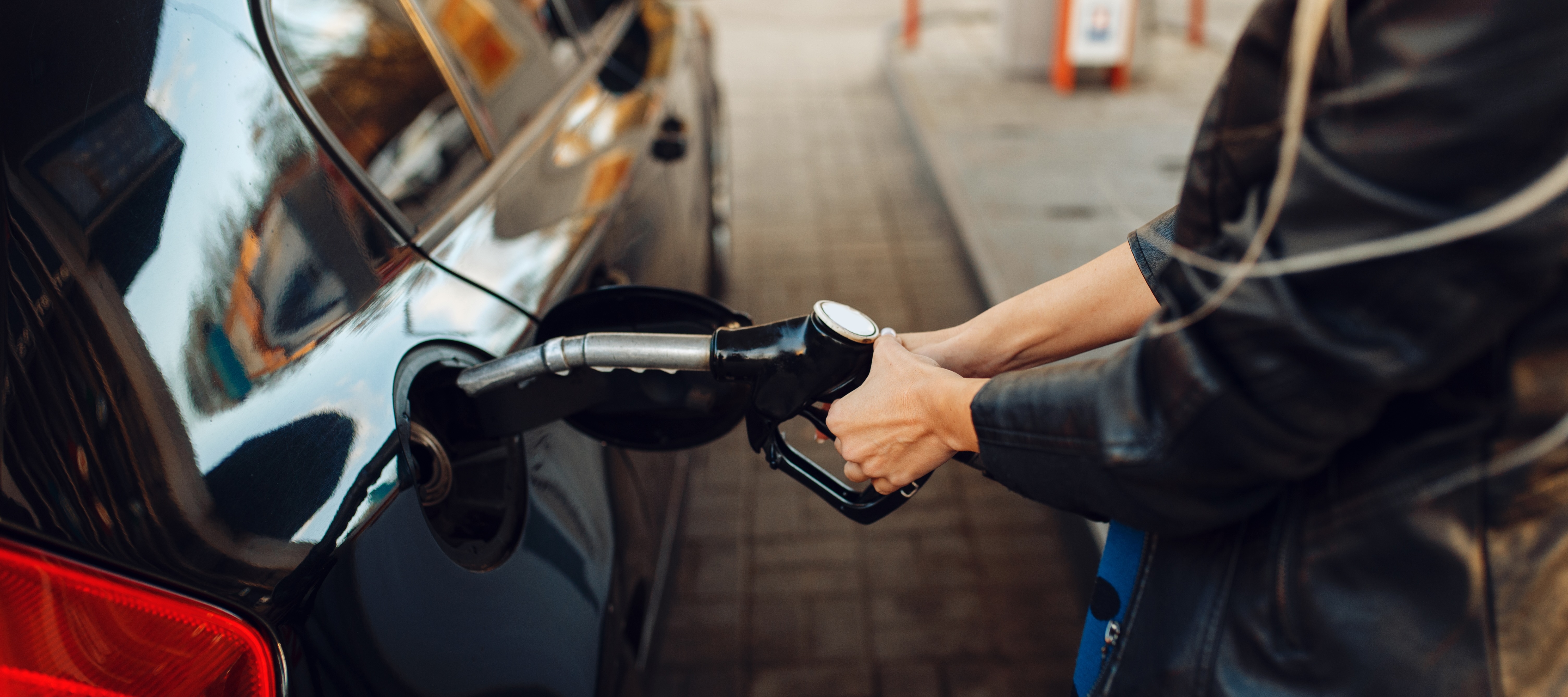 Woman filling car up with gas