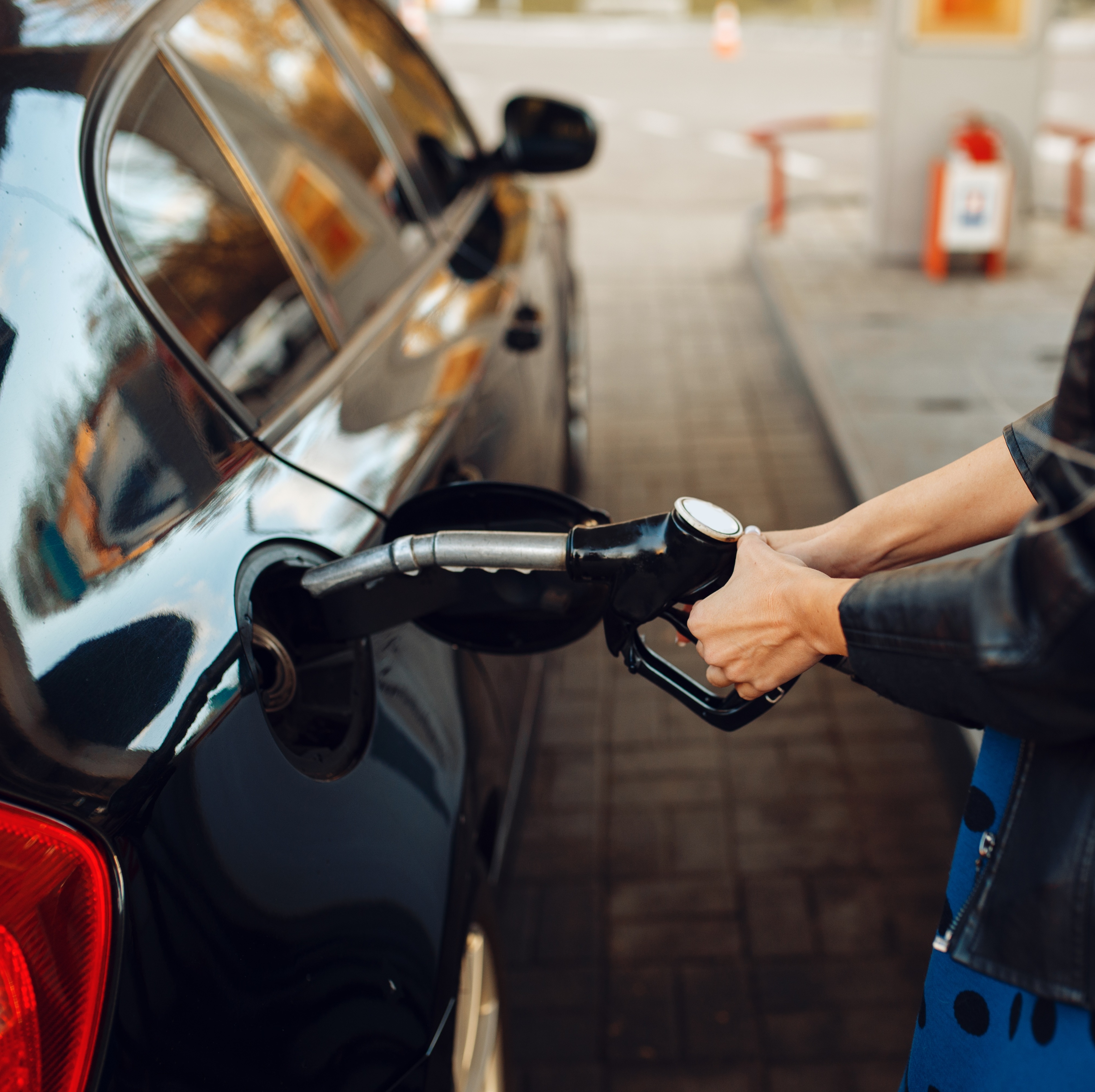 Woman filling car up with gas