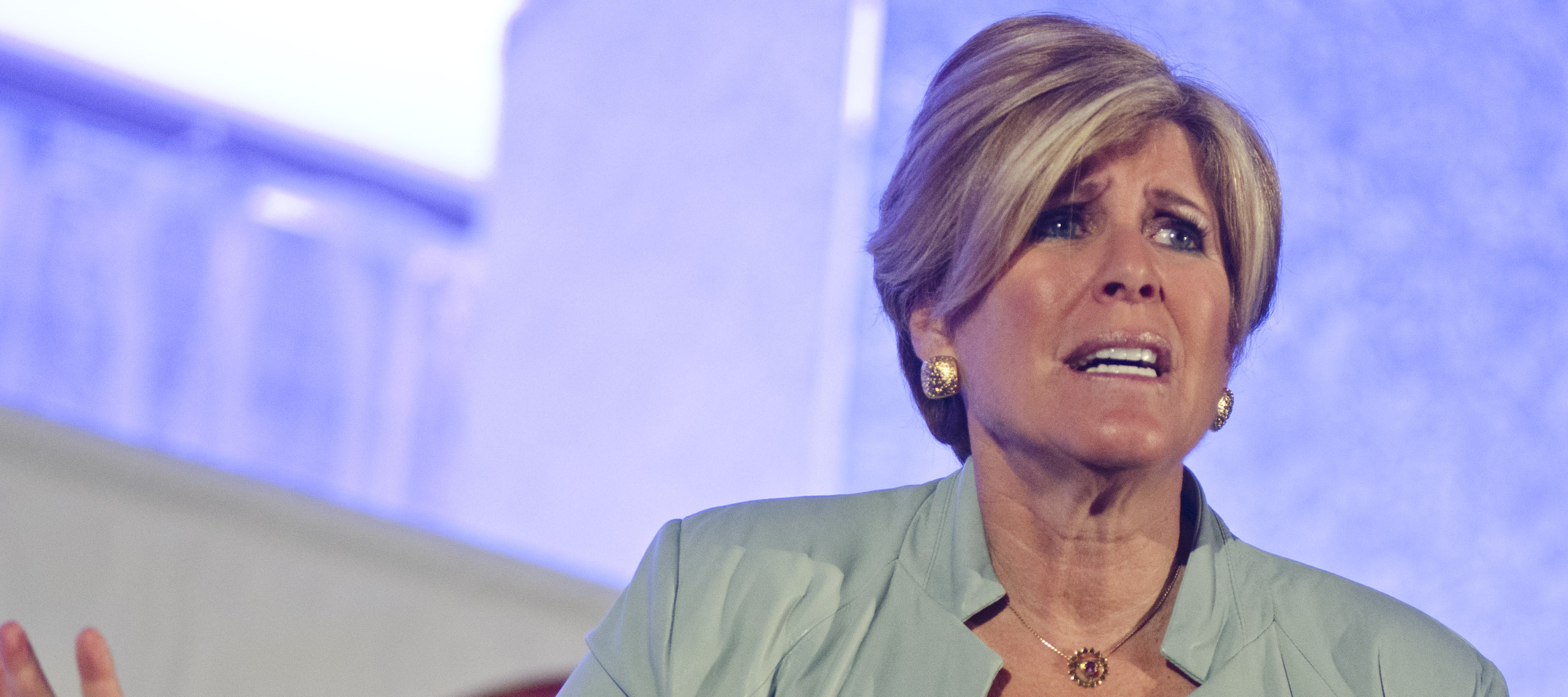 Suze Orman speaking at an event.