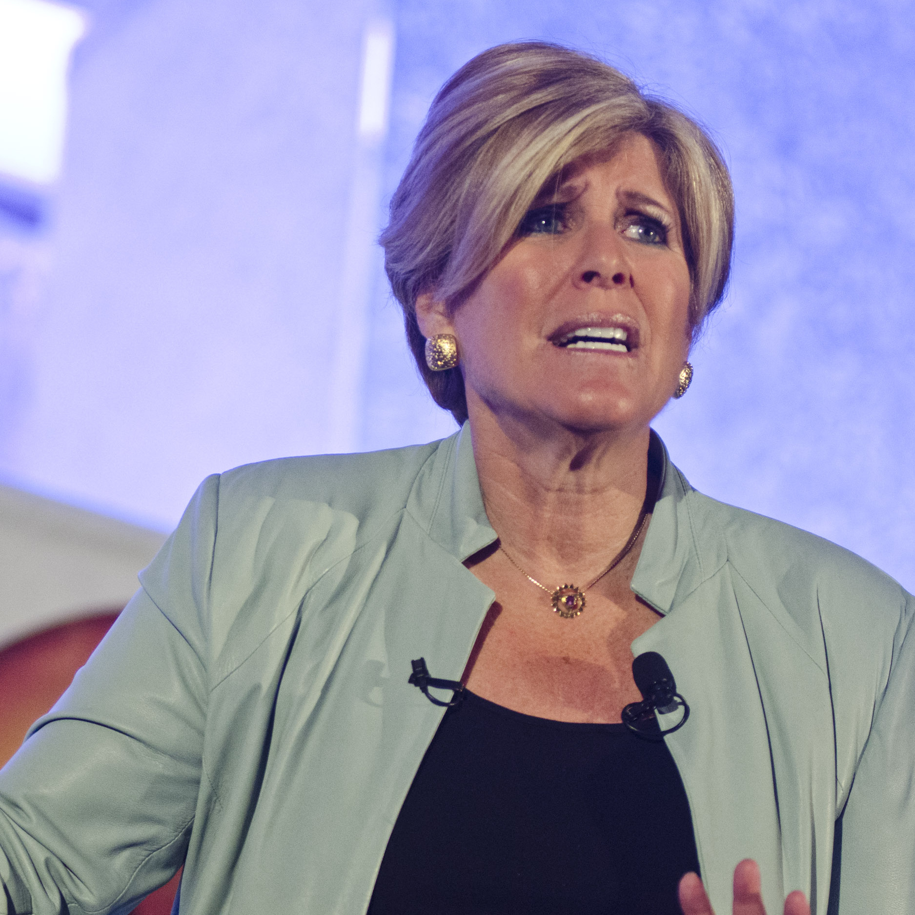 Suze Orman speaking at an event.