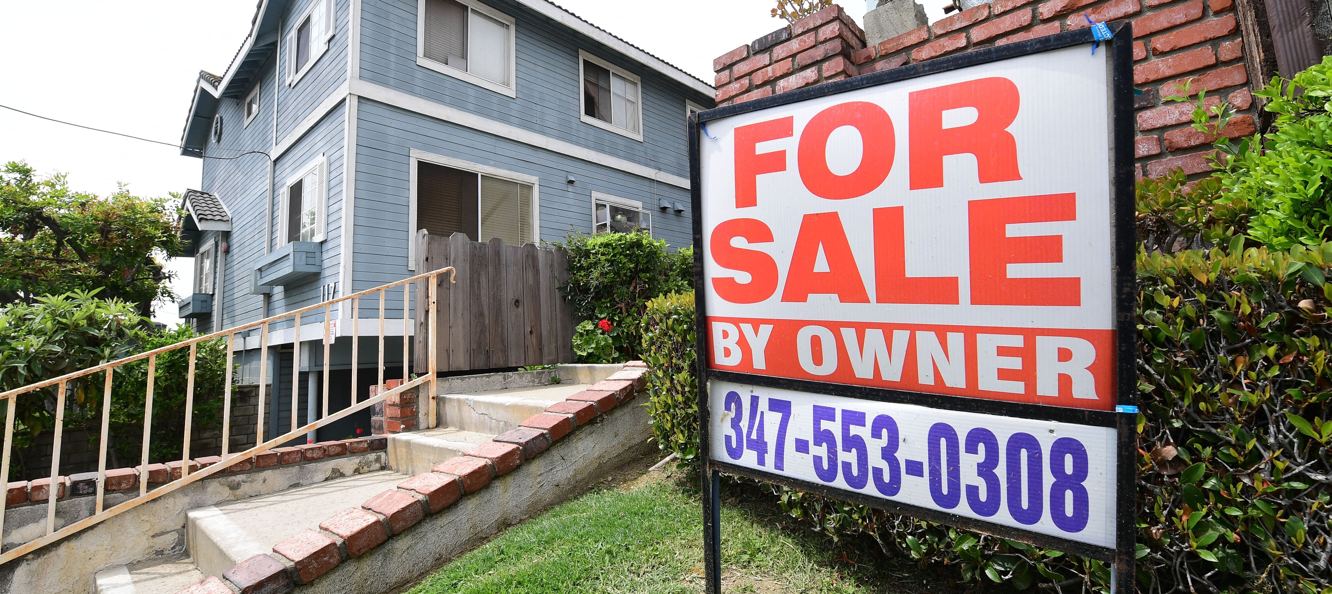 A "For Sale by Owner" sign is posted in front of property in Monterey Park, California.