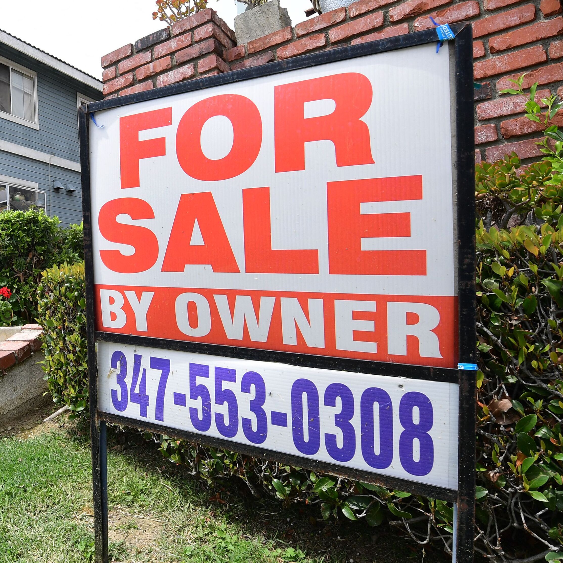 A "For Sale by Owner" sign is posted in front of property in Monterey Park, California.