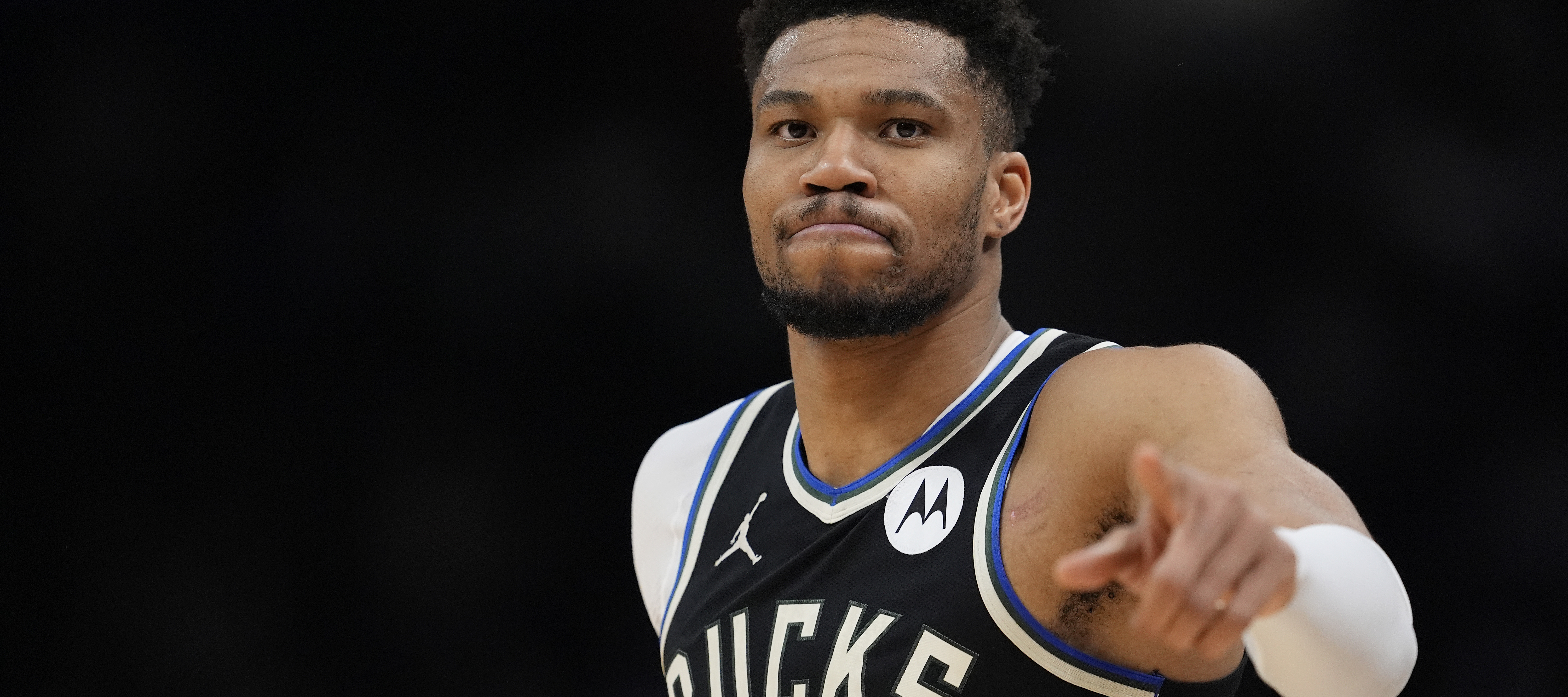 Giannis Antetokounmpo points to the camera during a basketball game against the Indiana Pacers.