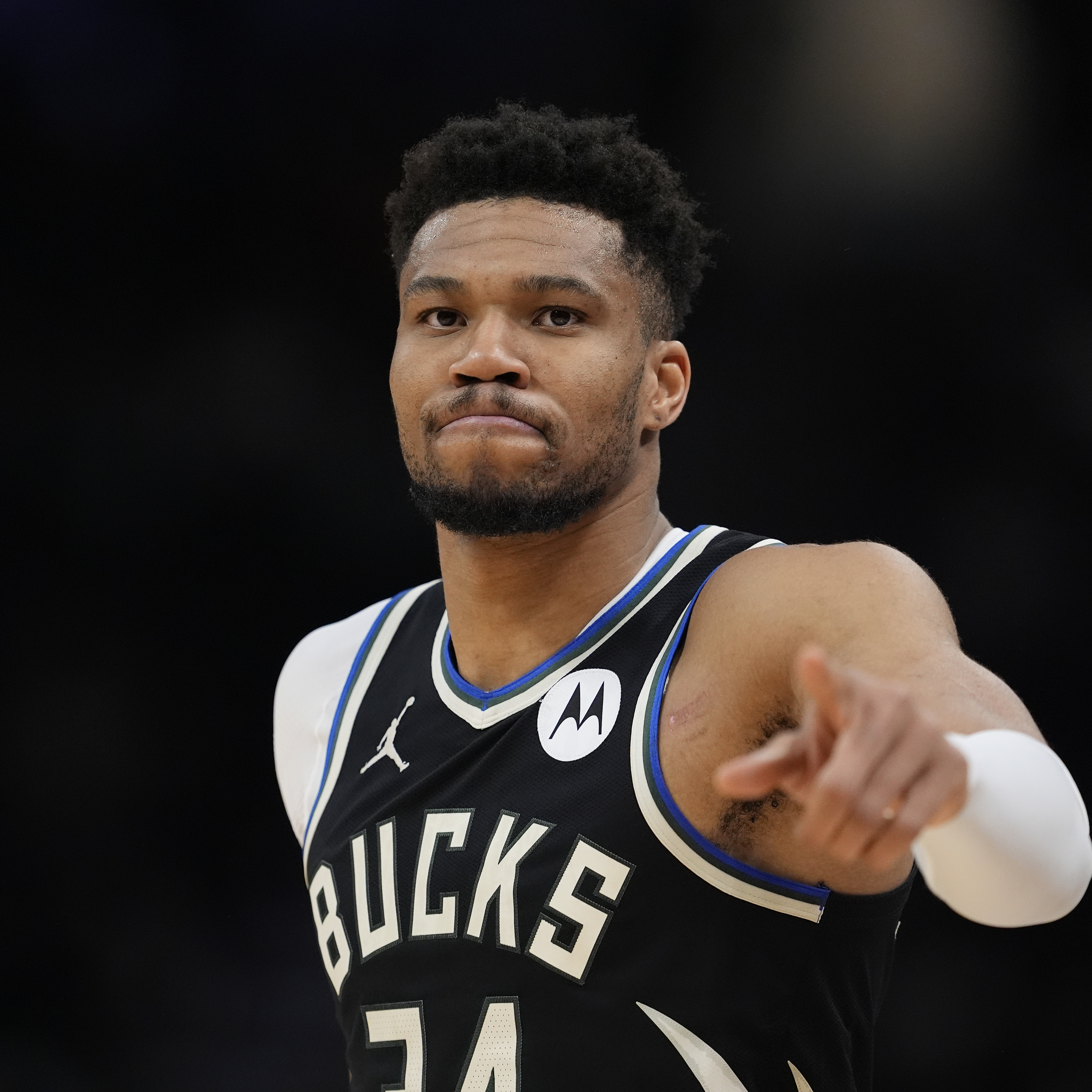 Giannis Antetokounmpo points to the camera during a basketball game against the Indiana Pacers.