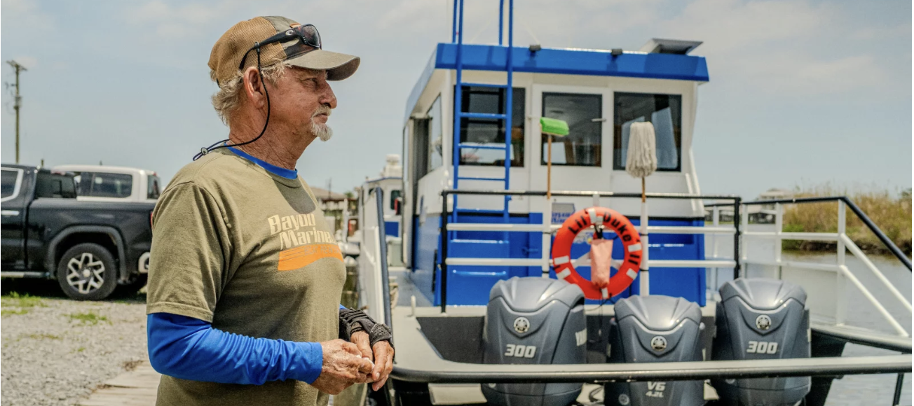 Acy Cooper, a gulf shrimper, is photographed at Myrtle Grove Marina during his lunch break on May 15, 2026.