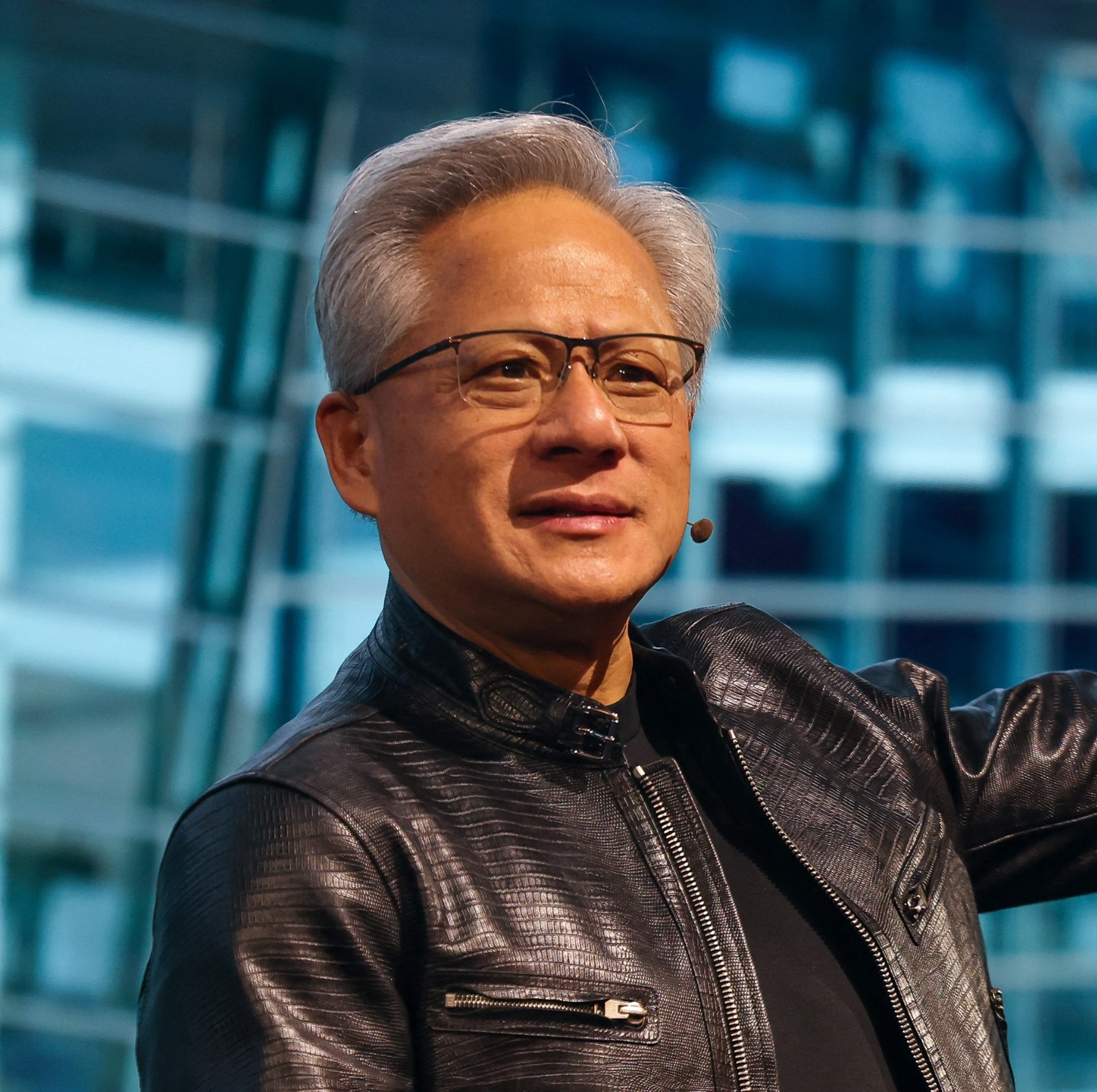 Nvidia CEO Jensen Huang lifts his arm and waves