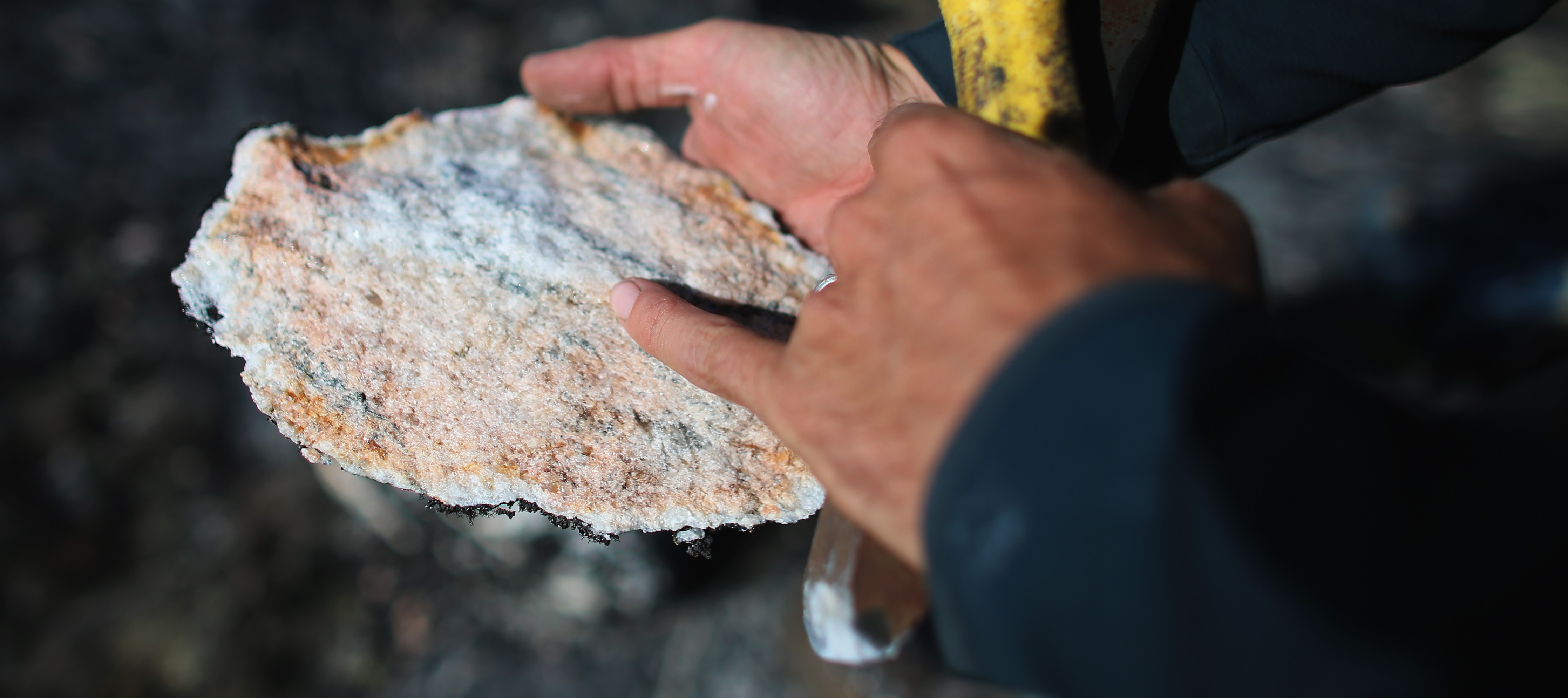 Jason Briner, with the University of Buffalo, Department of Geology, looks at a sample of granite.