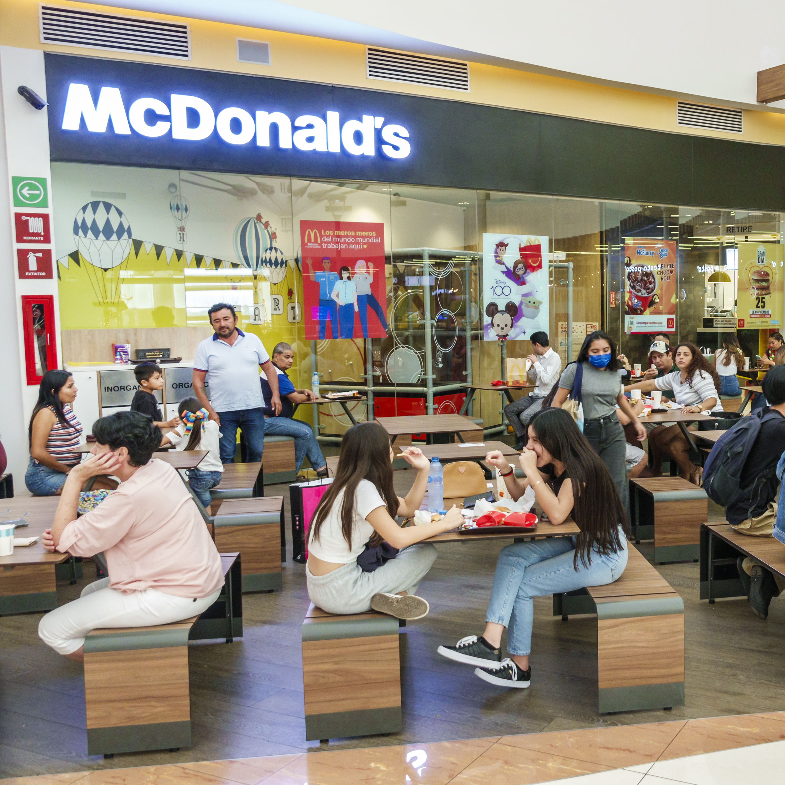The interior of a McDonald's restaurant inside of a mall.