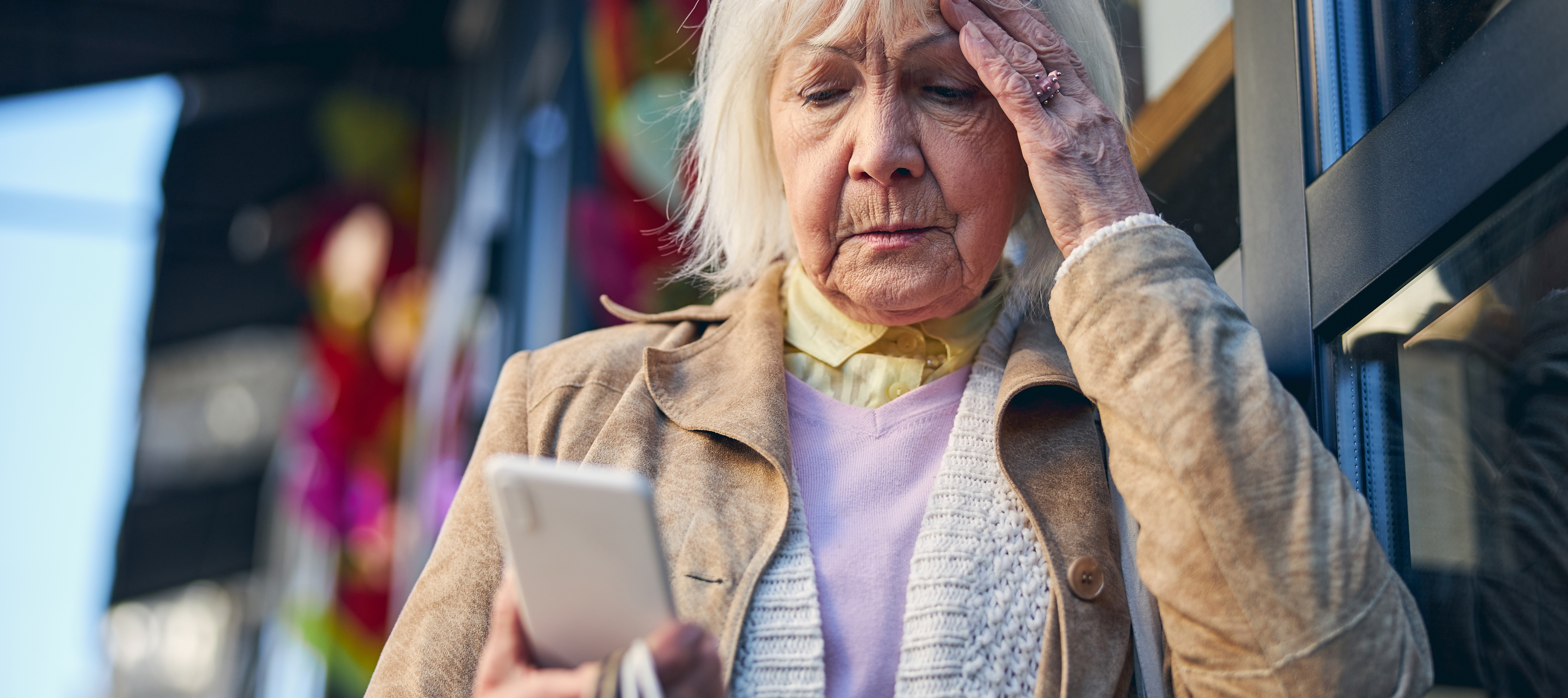 Older woman stressed looking at cellphone