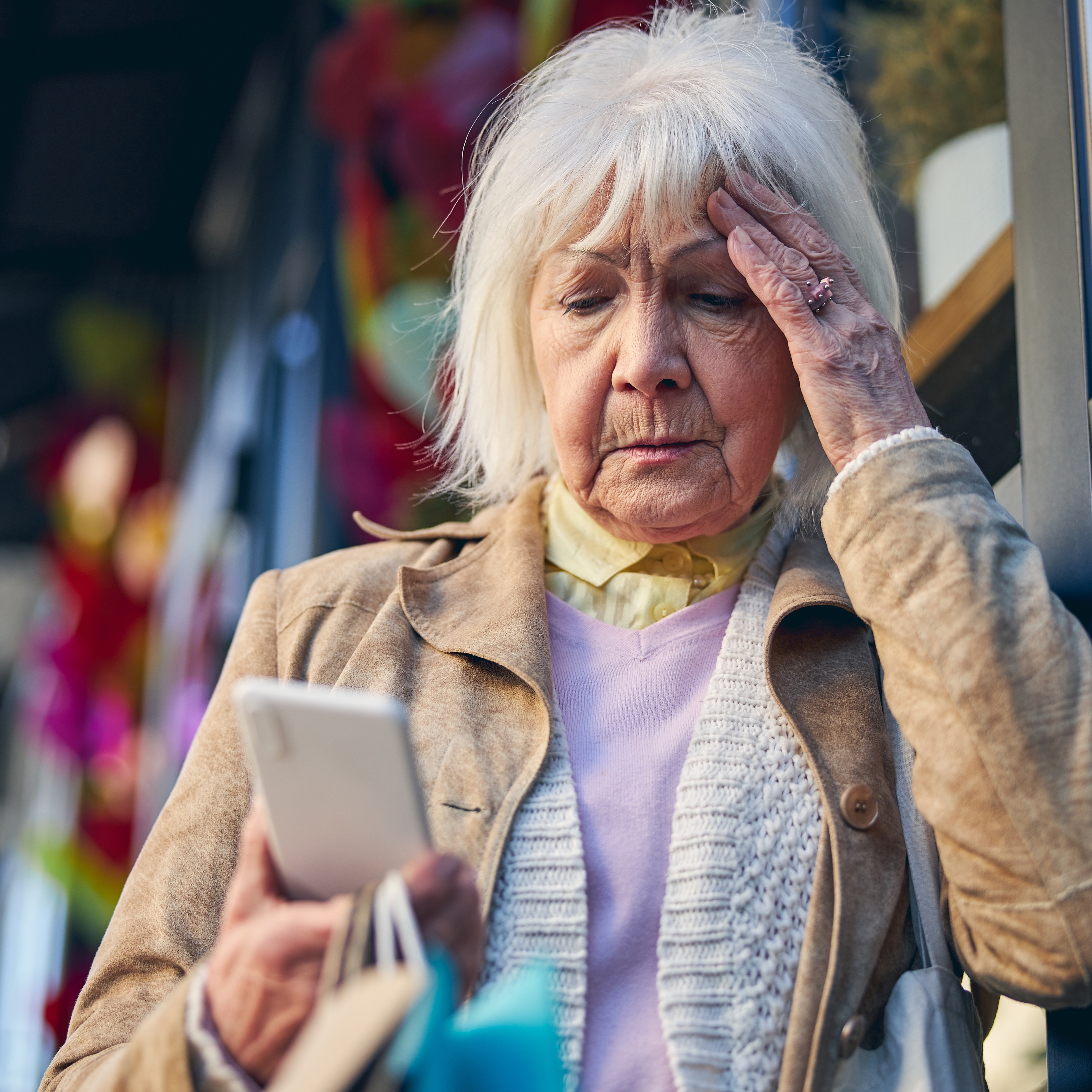 Older woman stressed looking at cellphone