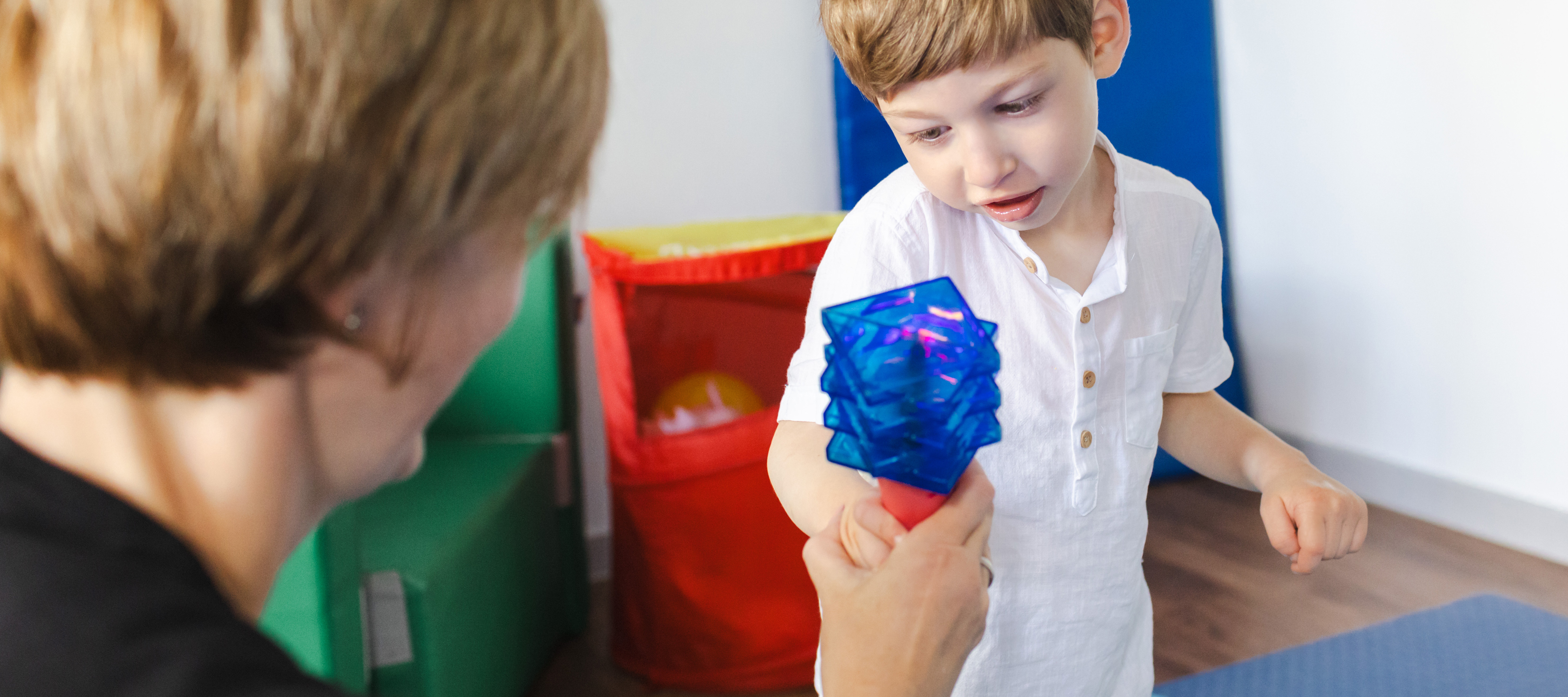 Child playing with toy with therapist