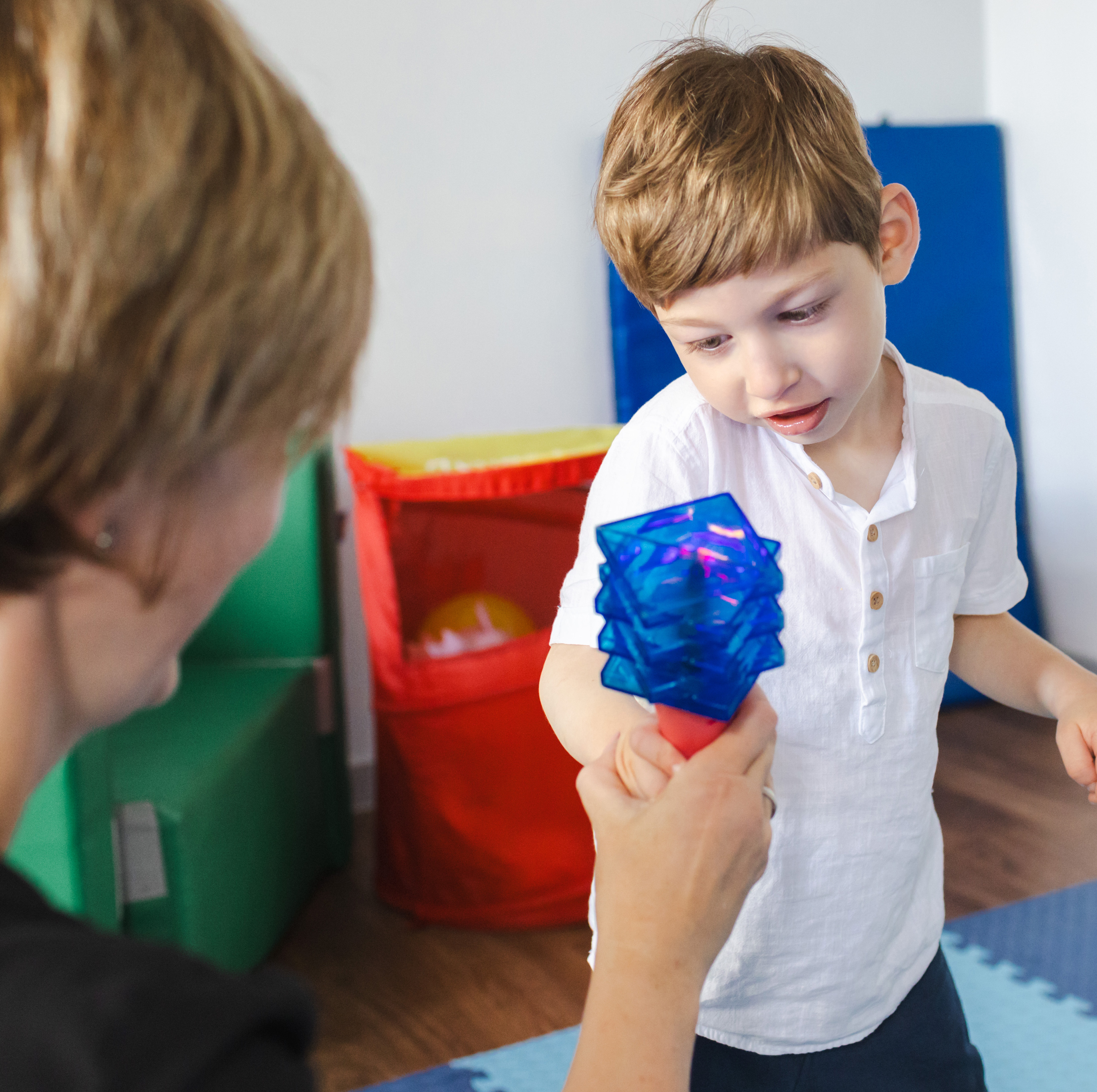 Child playing with toy with therapist