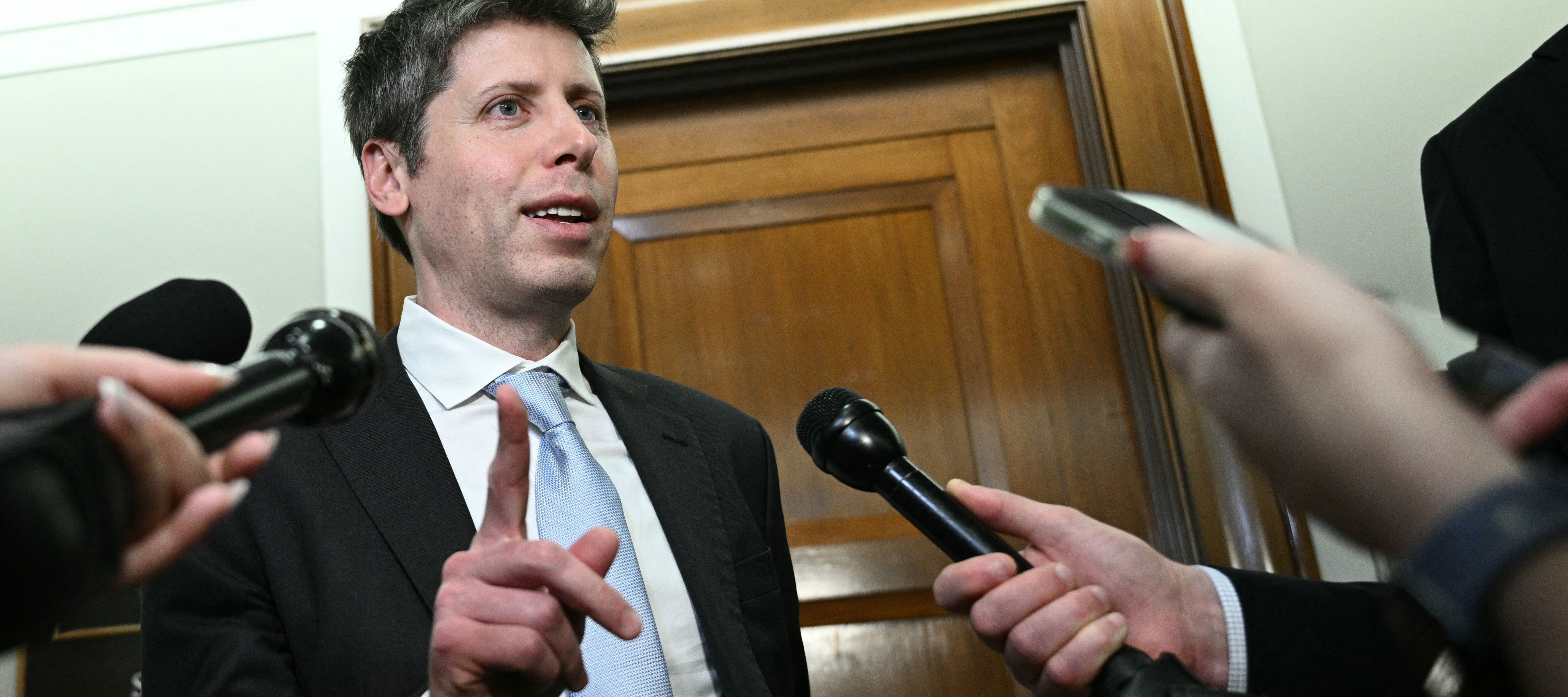 Sam Altman speaking to reporters