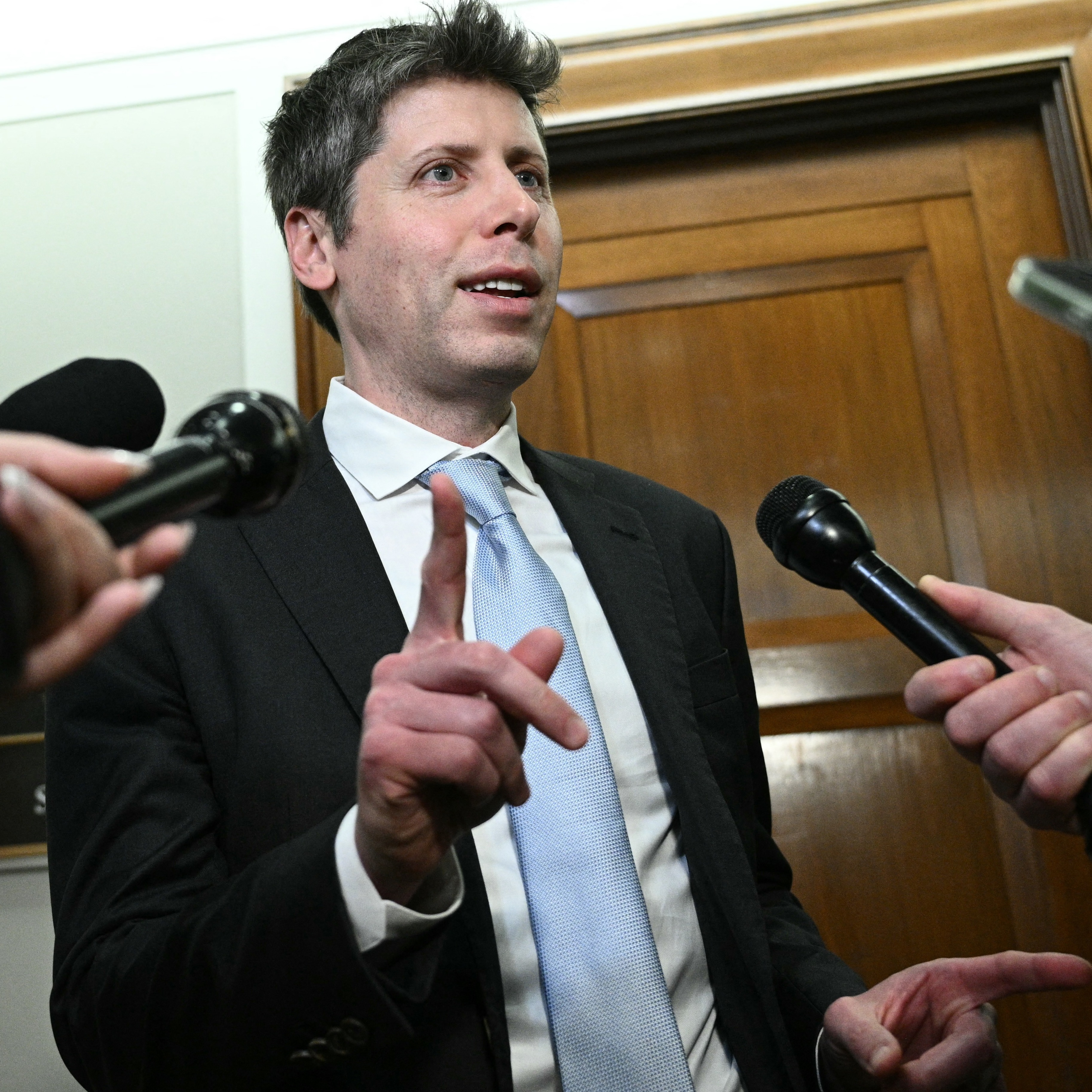 Sam Altman speaking to reporters