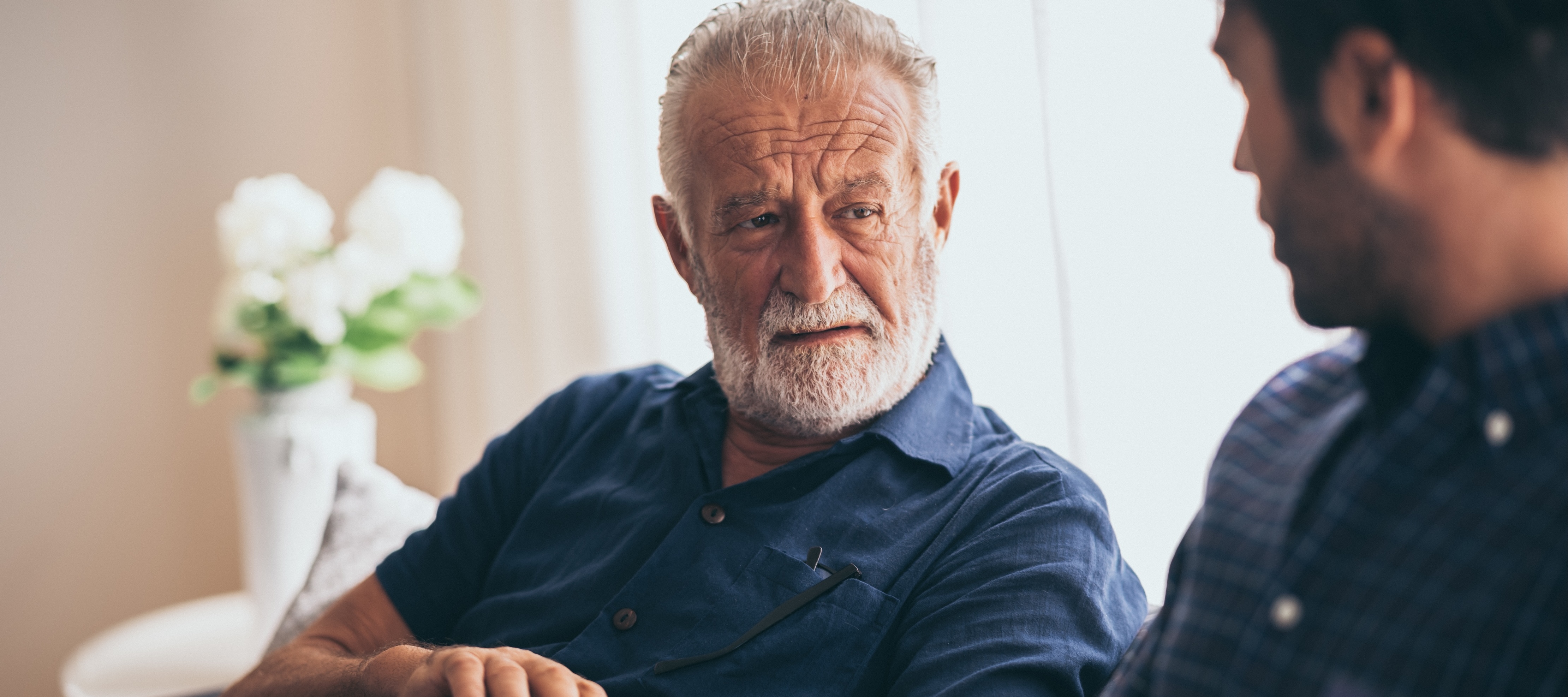 older man looking at son touching his watch
